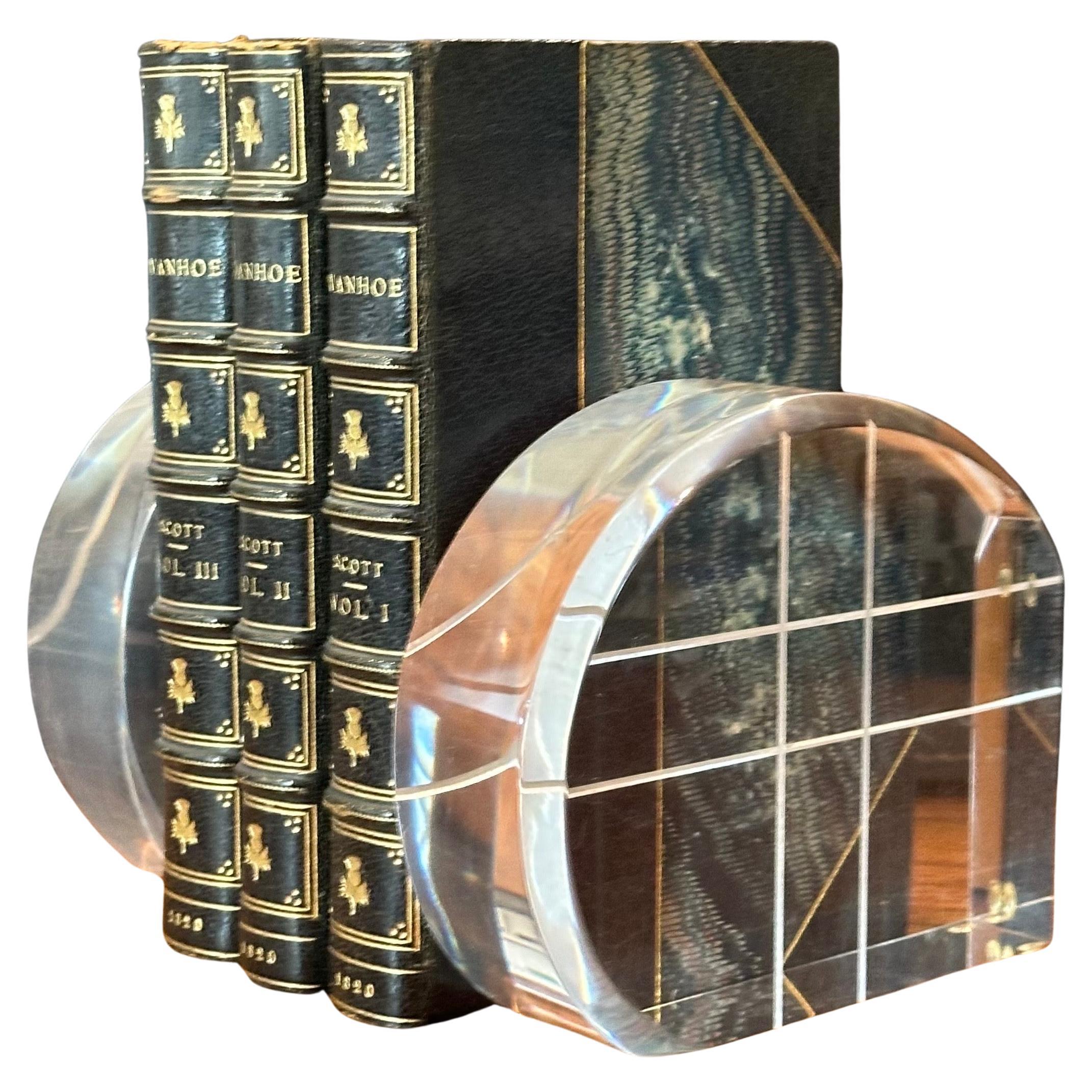  A nice pair of MCM arched lucite bookends in the Style of Herb Ritts for Astrolite, circa 1970s. The pair are in excellent condition and would make a great addition to any mid-century study or library! The measure a hefty 10