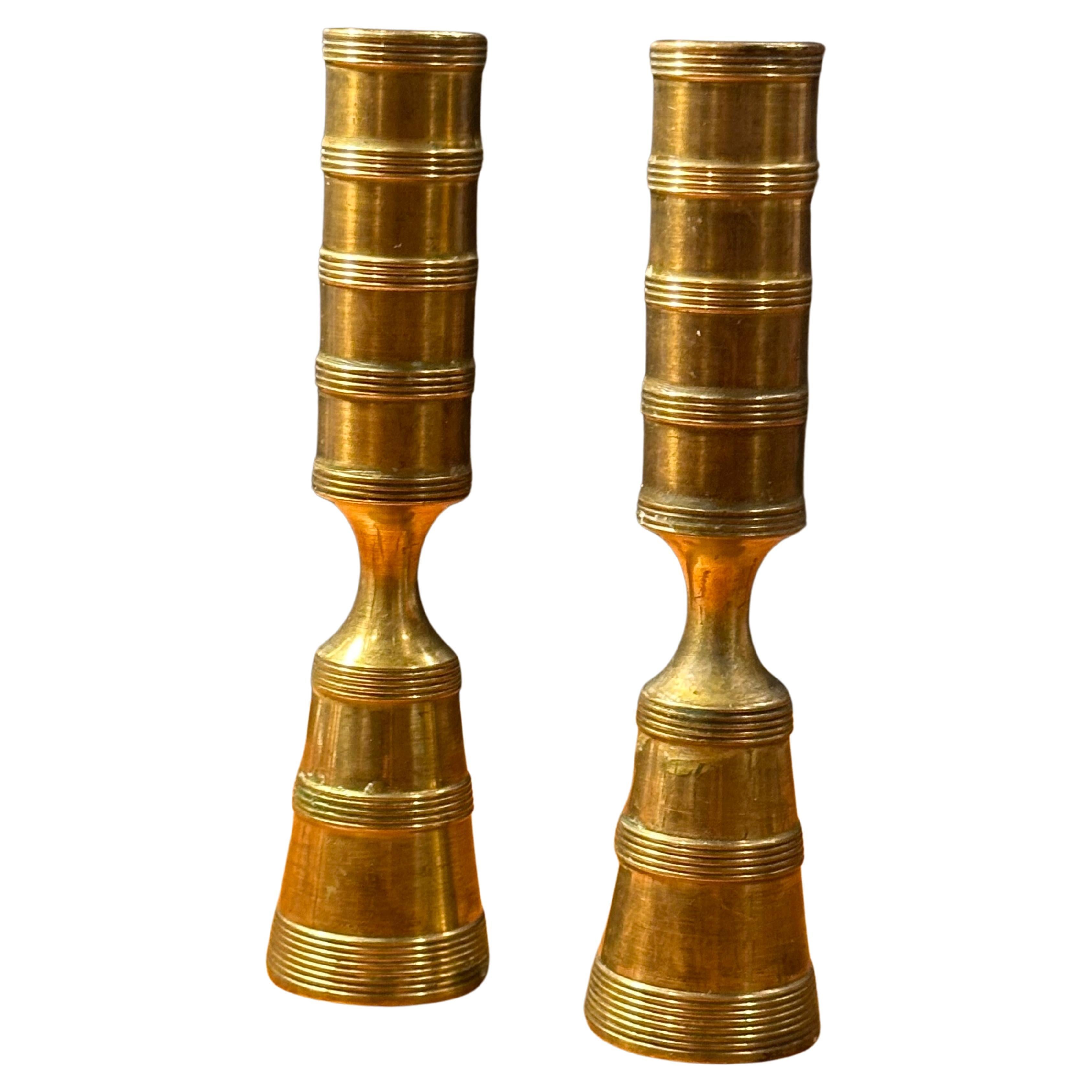 A rare pair of MCM brass turned candlesticks by Jens Quistgaard for Dansk, circa 1950s.  The set is in good vintage condition with a nice patina and measures 1.5