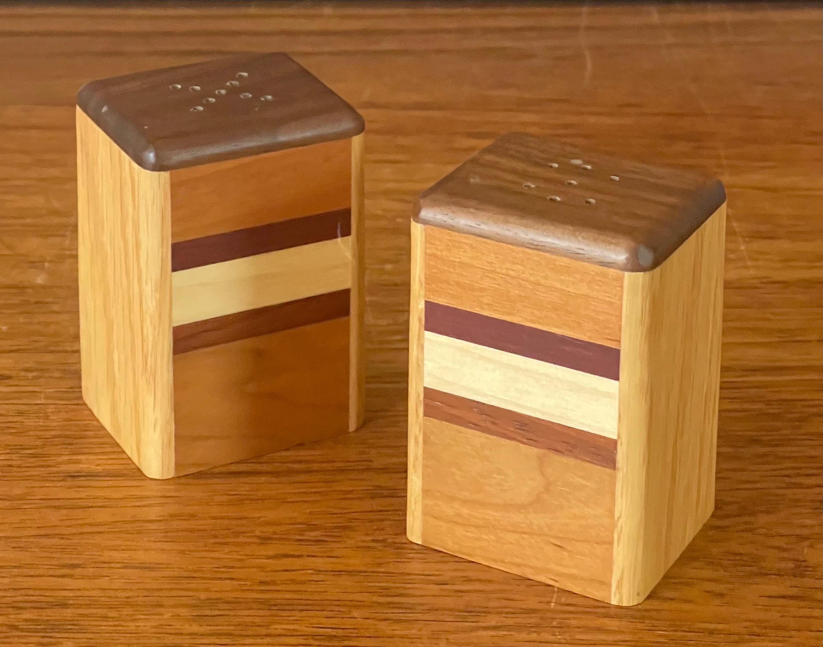 A very nice pair of MCM mixed woods salt and pepper shakers, circa 1970s. The set is constructed of ash, beech, walnut and teak wood to make a very colorful and effective Shaker. The pair are in very good condition and measure 3.75