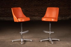 Pair of MCM Orange Vinyl Swivel Chairs by Chromcraft