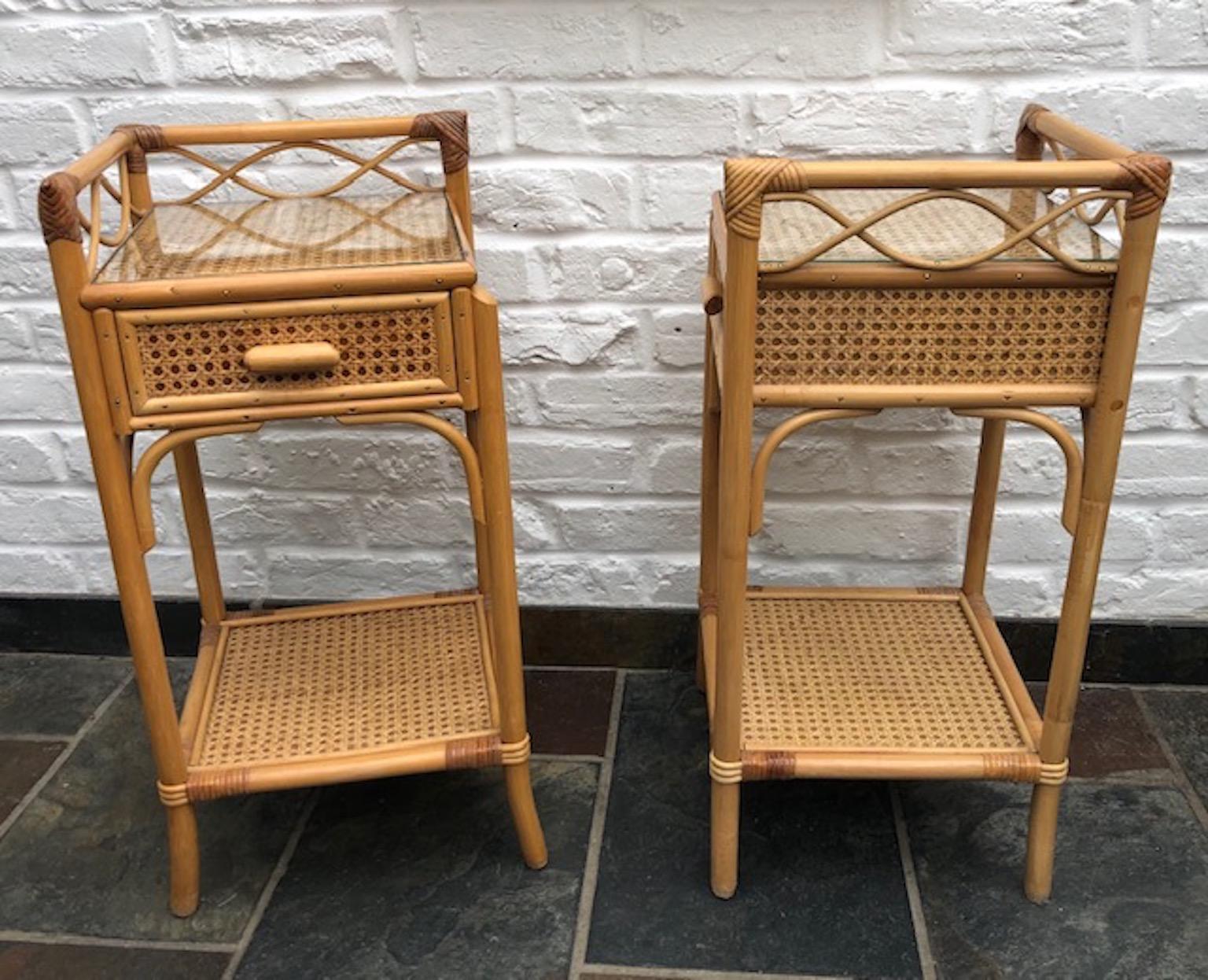 Pair of mid century rattan / cane nightstands / bedside table by English company, Angraves, England, 1970s

Each nightstand has 1 x drawer with a cane handle, and a shelf below, they are covered in cane weave matting, and 
each have new glass for