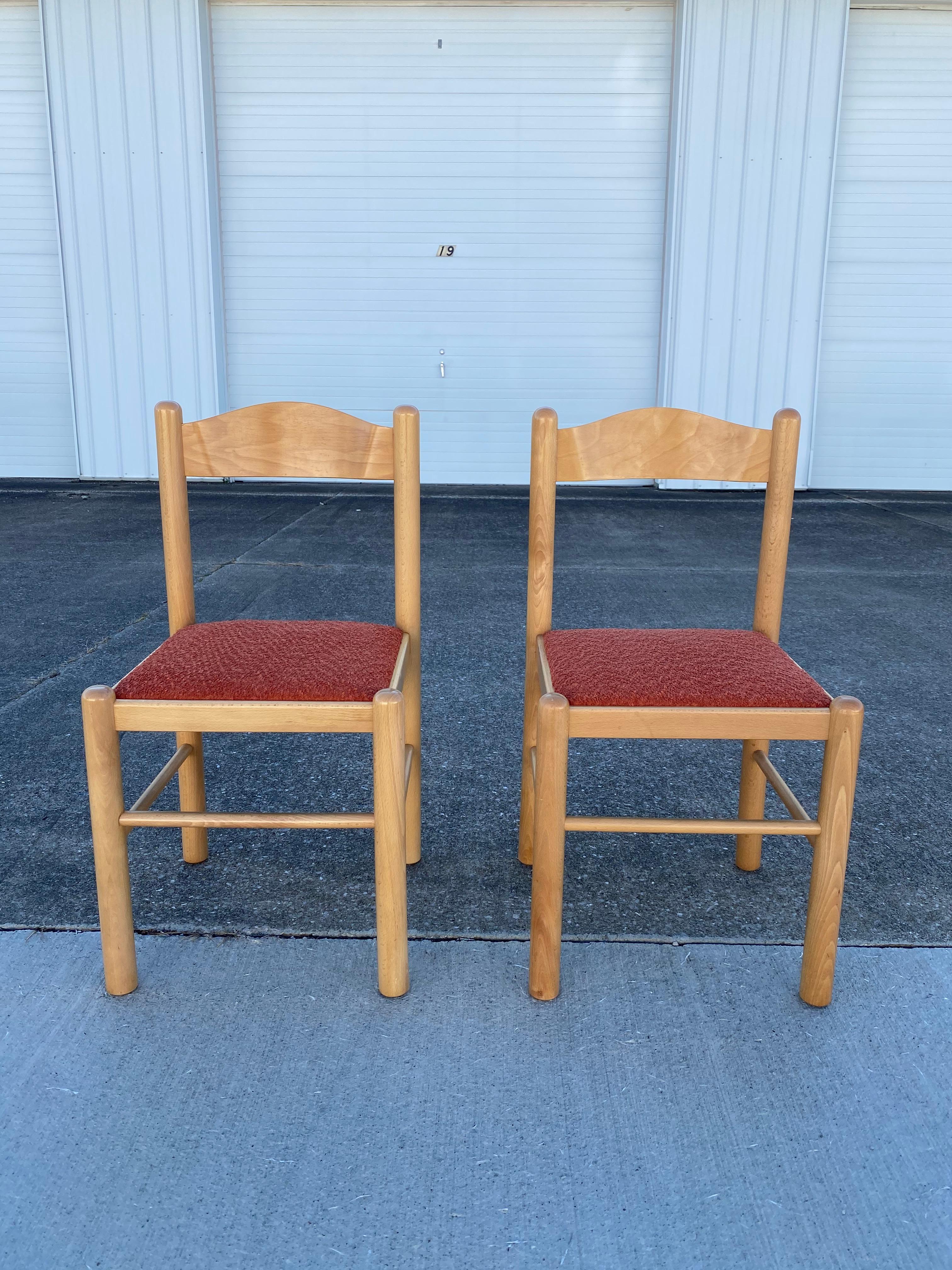 Pair of mid-century modern blonde Beachwood dining chairs, in the style of Vico Magistretti. Professionally reupholstered in a performance orange boucle. This new fabric brings out the gorgeous wood color. If you take a look at the pictures