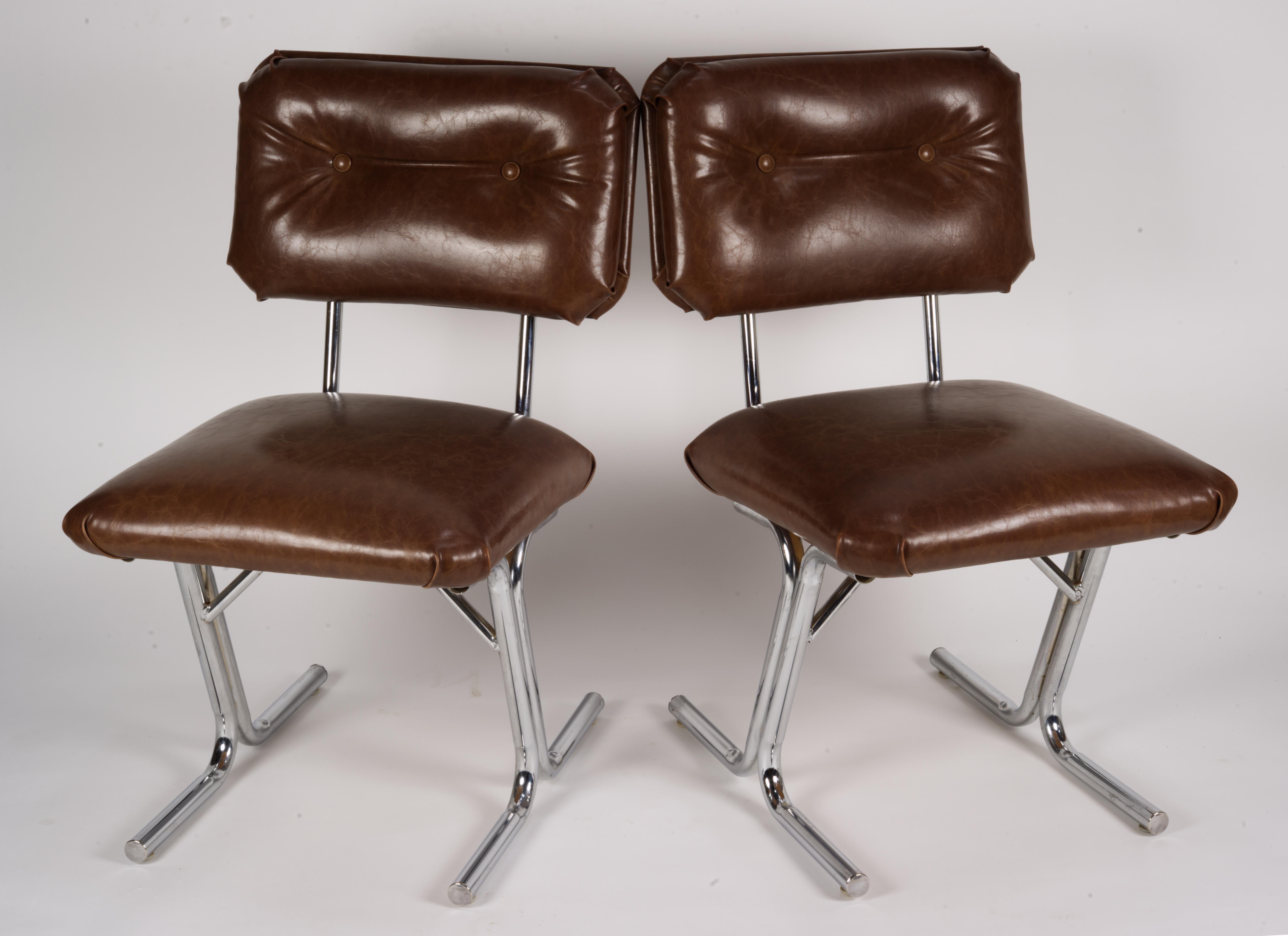 Pair of MCM side chairs in steel and brown vinyl. 
Minor wear on the steel. Vinyl has couple of 0.25