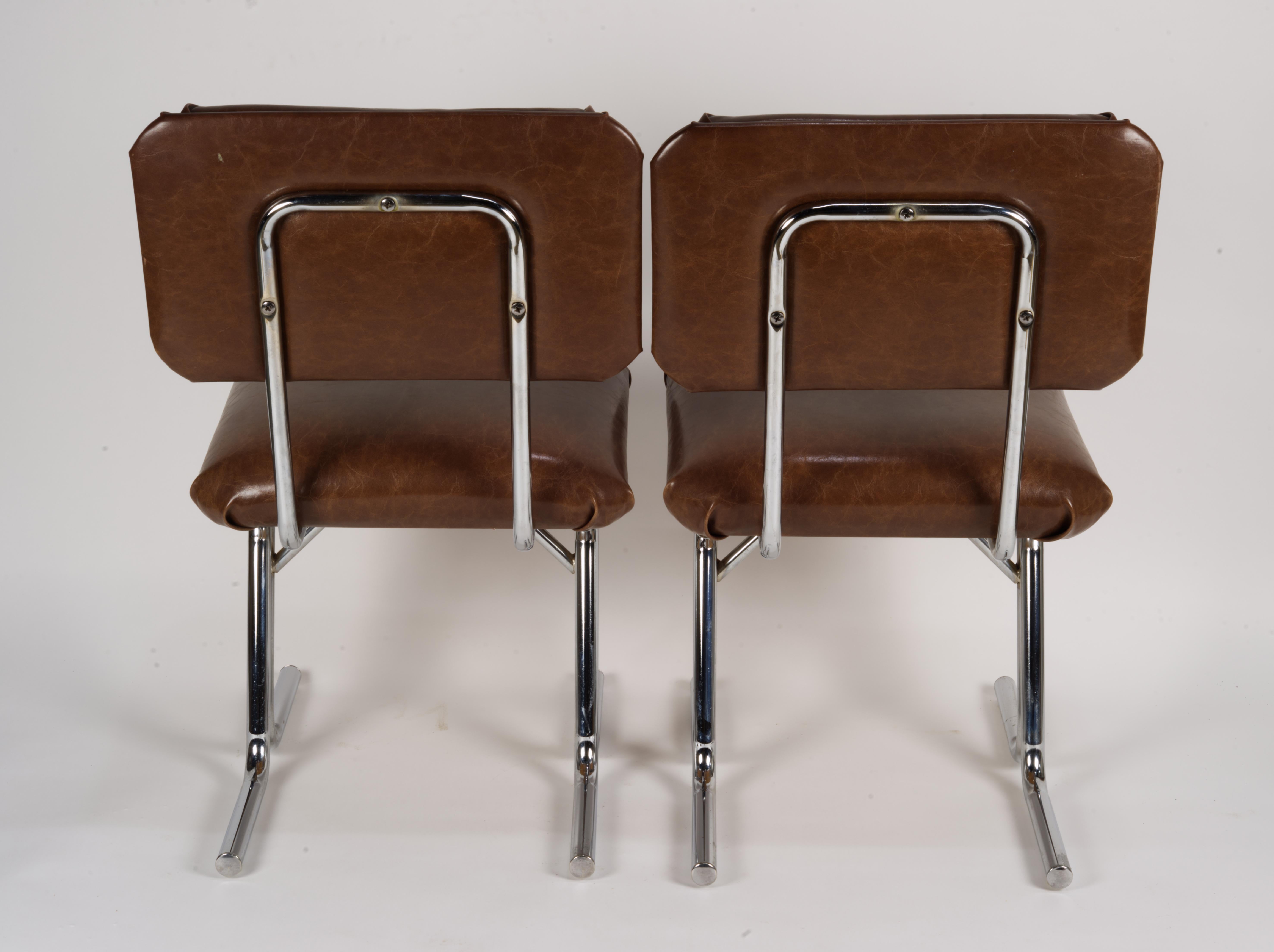 Pair of MCM side chairs in steel and brown vinyl.  In Good Condition For Sale In Clifton Springs, NY