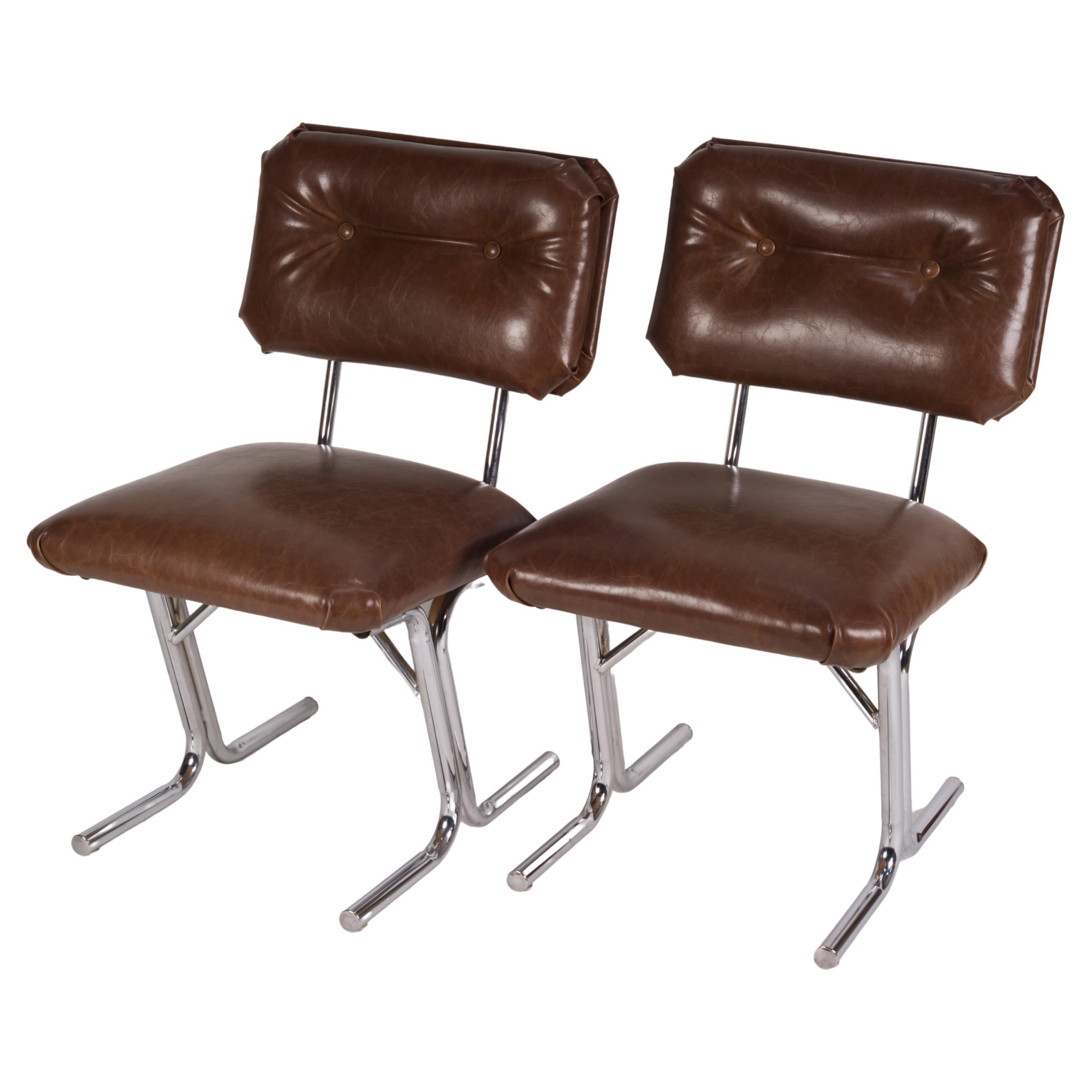Pair of MCM side chairs in steel and brown vinyl.  For Sale