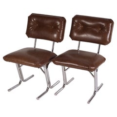 Retro Pair of MCM side chairs in steel and brown vinyl. 