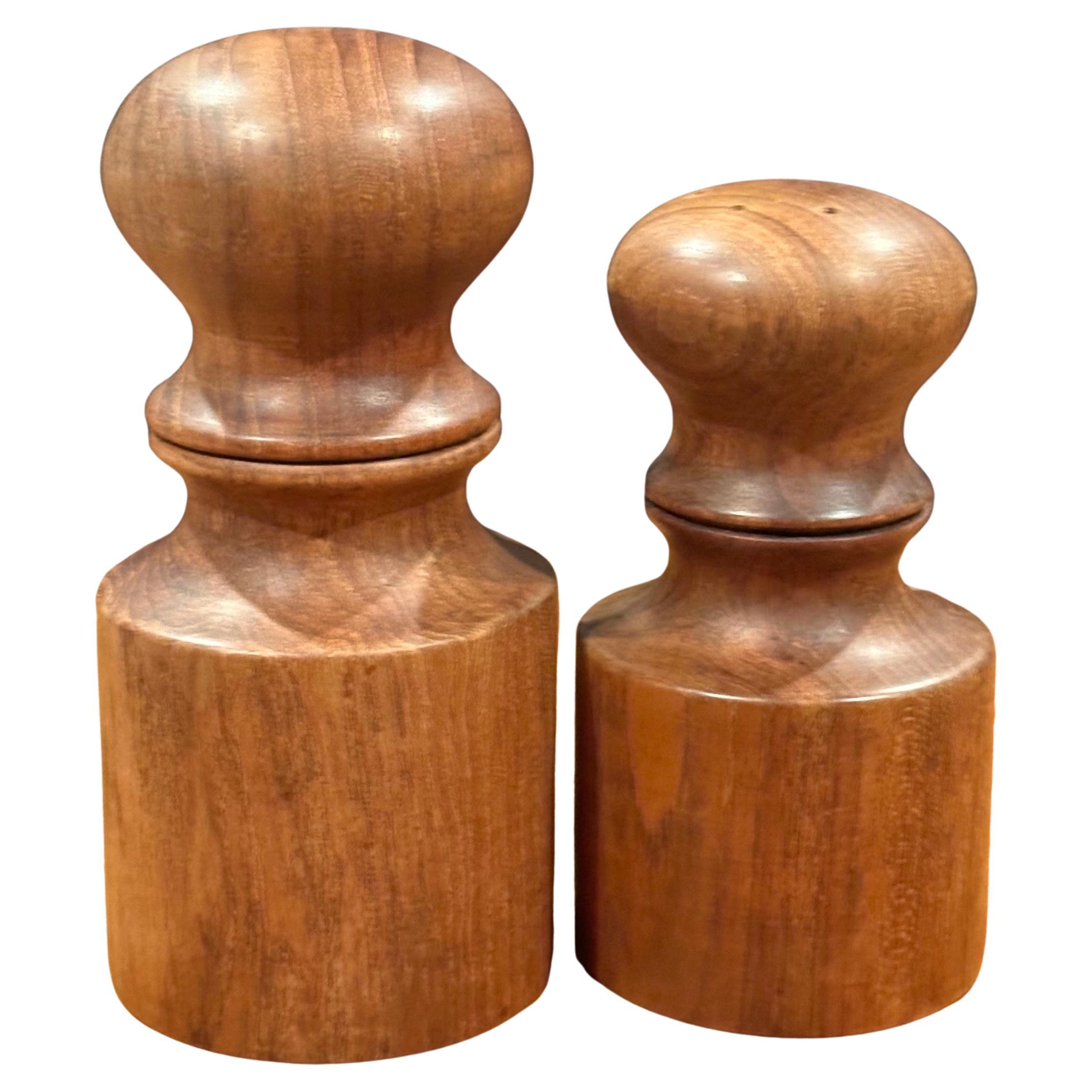 Pair of MCM teak salt and pepper shakers by Jens Quistgaard for Dansk, circa 1970s.  The set are in very good vintage condition and measure as follows:   

Salt         2.5