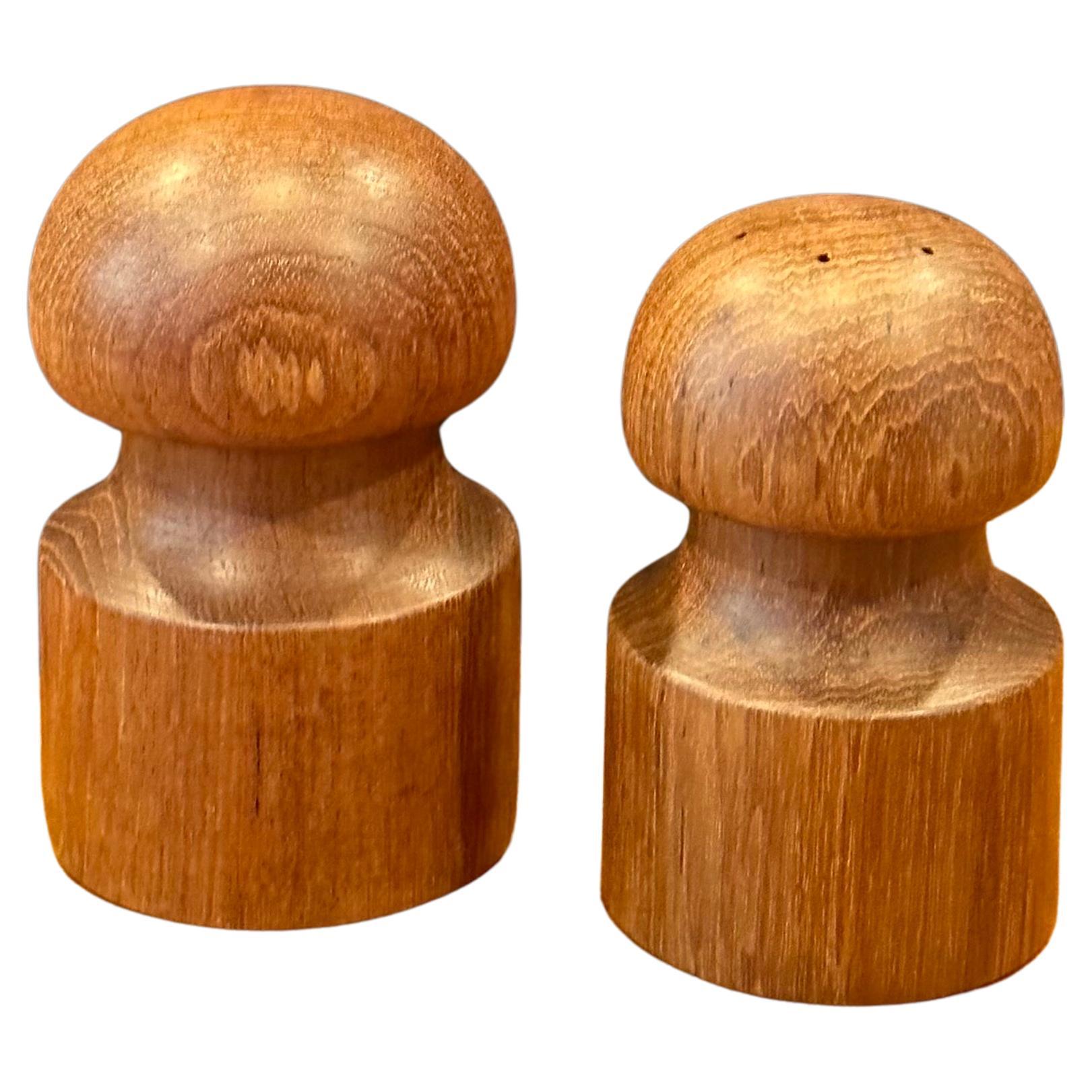 Pair of MCM teak salt and pepper shakers with original box by Jens Quistgaard for Dansk, circa 1970s.  The set are in very good vintage condition and measure as follows:   

Box        8