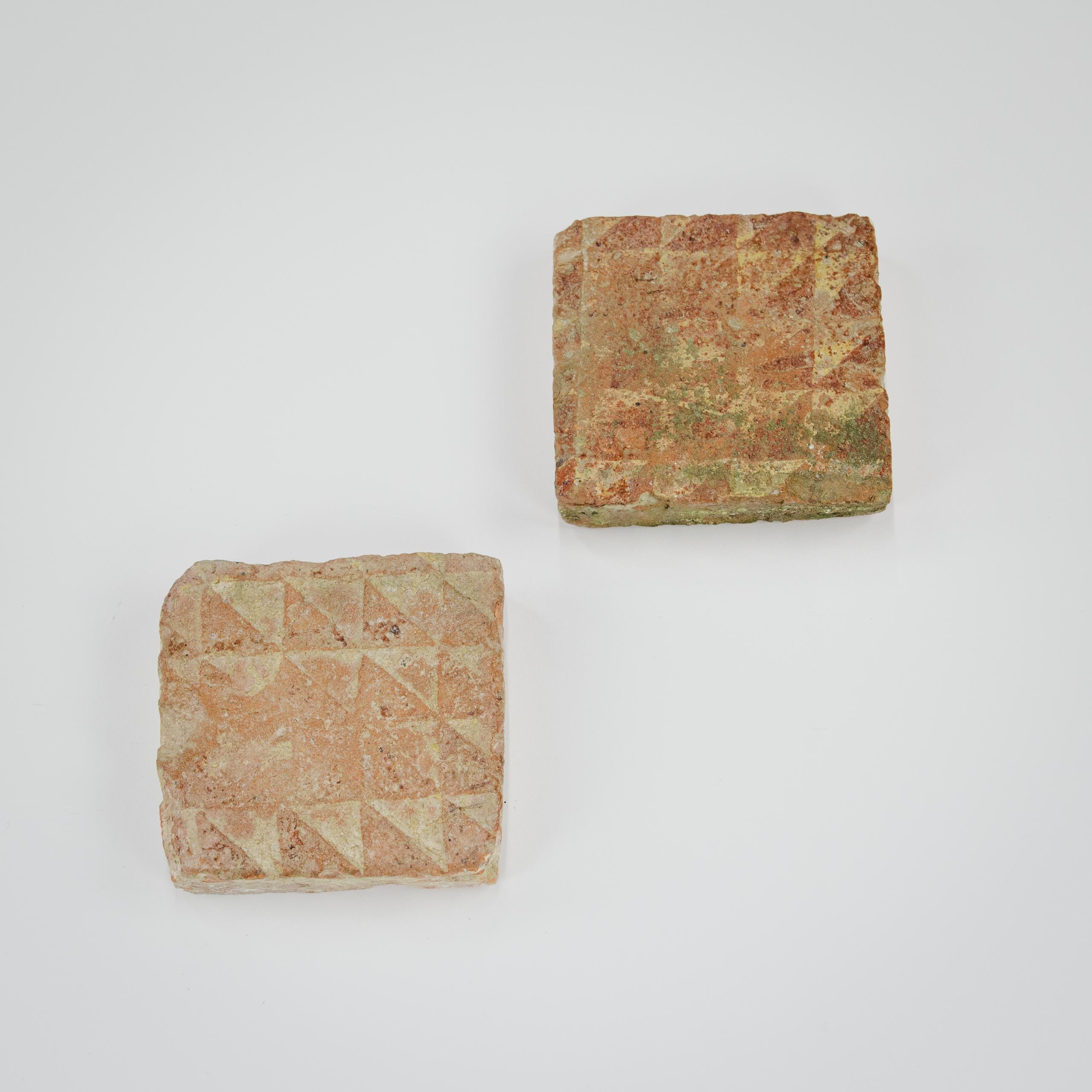 Pair of Medieval encaustic floor tiles, each with a geometric pattern. Heavily worn. Similar examples can be found at Winchester Cathedral. UK. 12-14th Century.