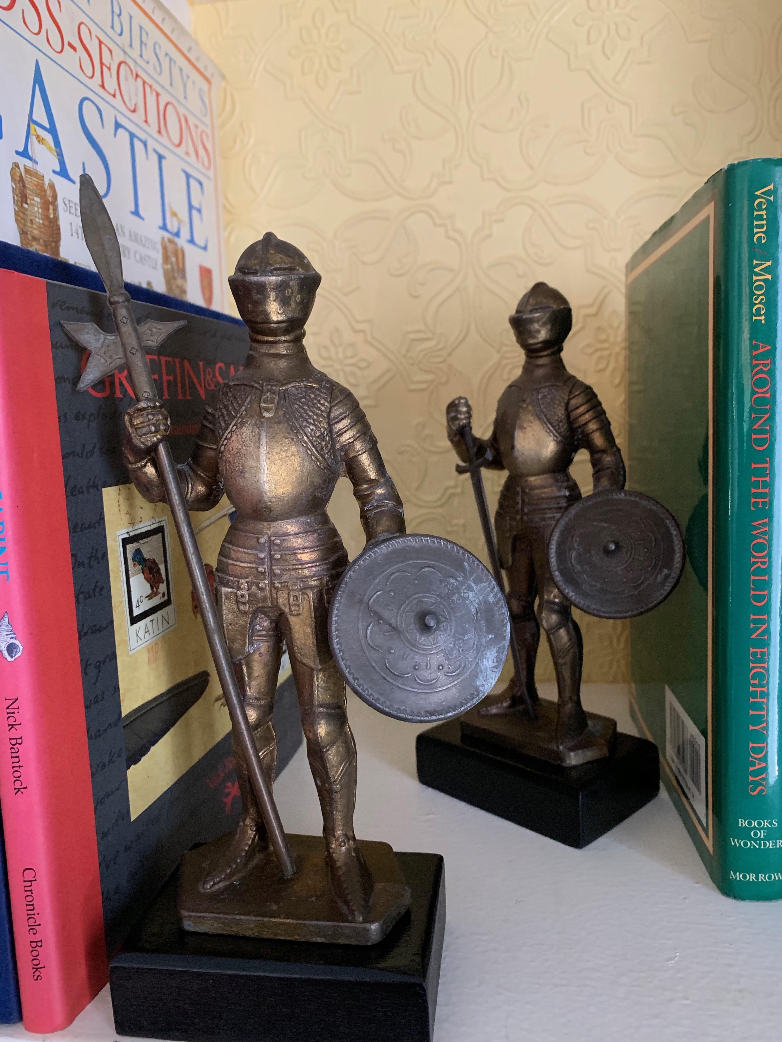 A fantastic pair of lit metal knights with removable swords, that could be used for letter openers... each knight is holding a shield and stand atop a black wood base. The pair are of substantial weight, at 1.5 pounds each.... and handsome on any