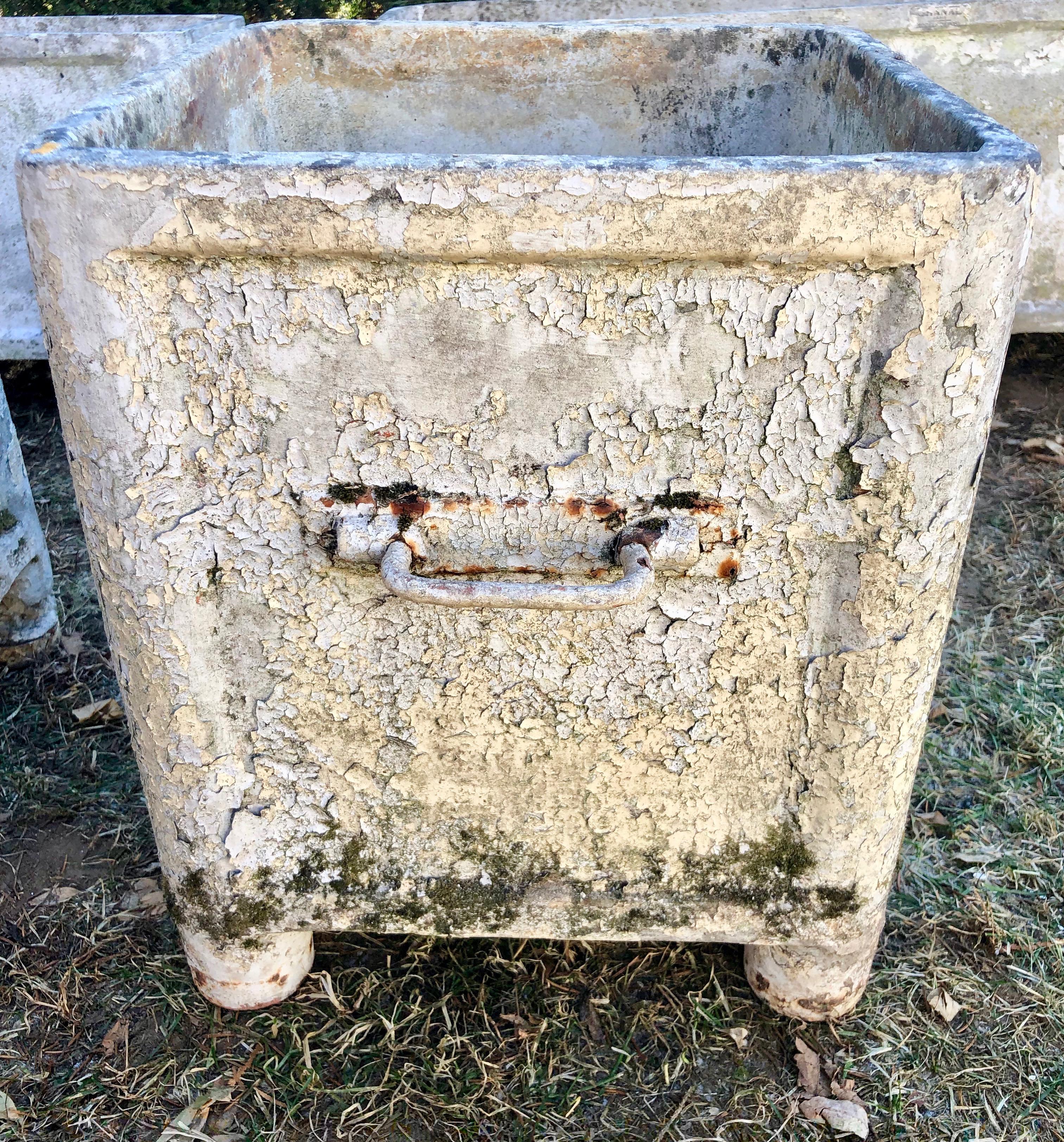 We see pieces by the famous French maker, Chanal, from time to time, but this pair of medium-sized square planters is wonderful for lovers of truly crusty patina. In an exceptional weathered and greening surface with traces of crusty white paint