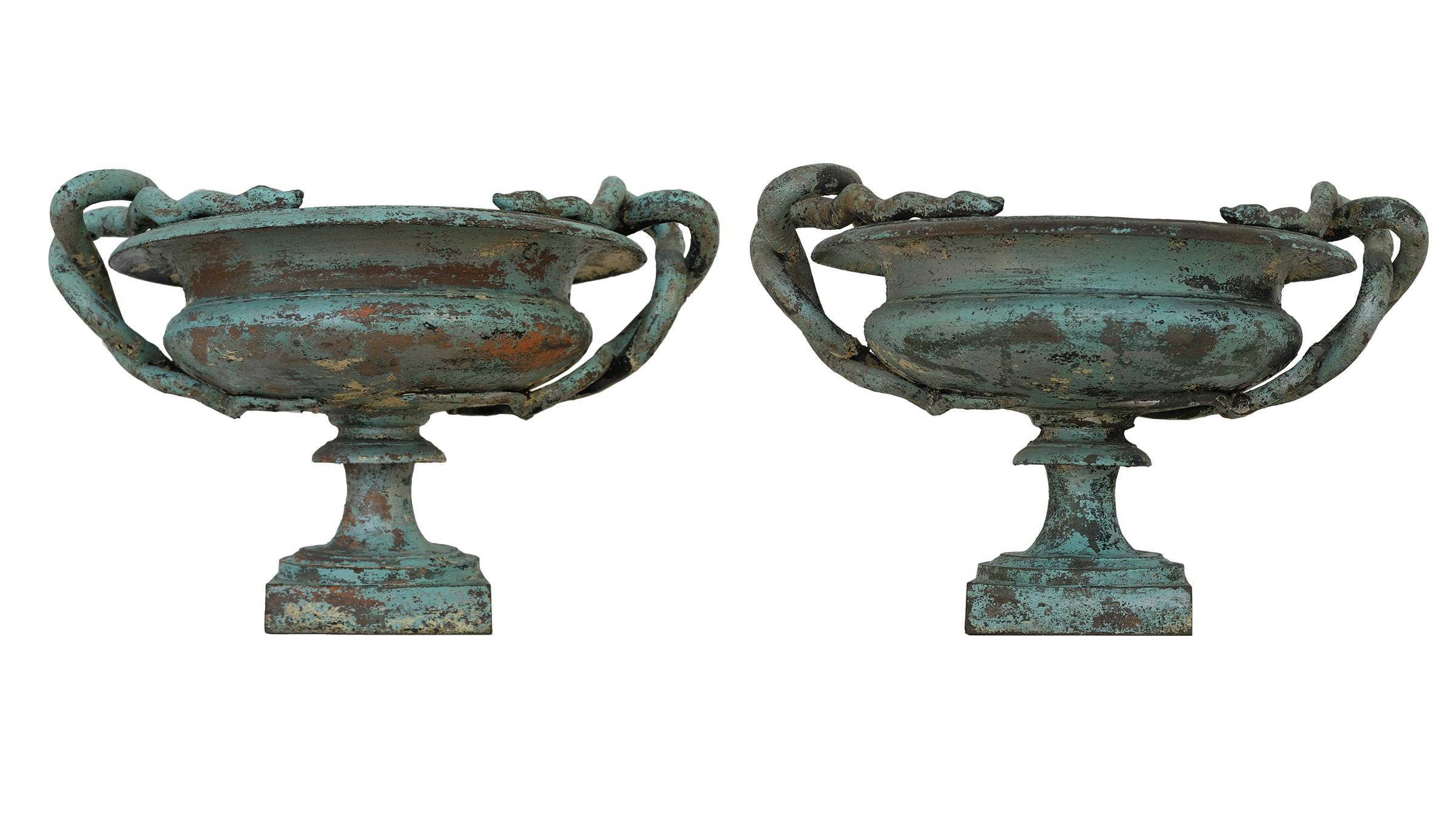 A pair of medium Val d’Osne cast iron snake urns with a robin’s egg blue patina. Exquisite tones of brown rust and very rare robin's egg blue patina. Marked with the number 2 denoting the medium size of the three sizes made by the renown Val d'Osne