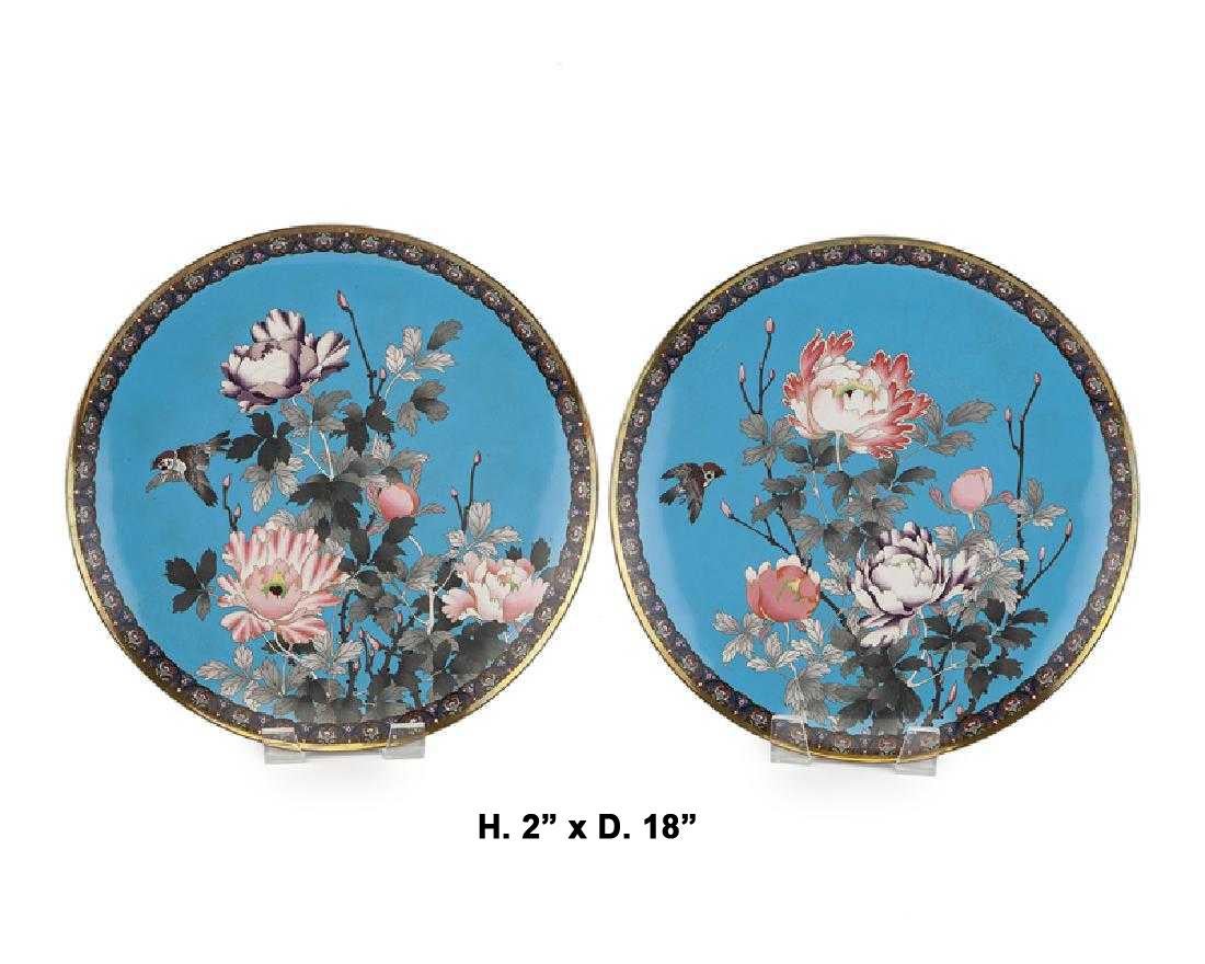 Fine pair of antique Meiji period Japanese Cloisonne chargers, late 19th century.
Intricate enamel over brass cloisonne portraying a colorful floral and foliage motif with flying birds. 

Could be purposed as a table article with a stand or hung