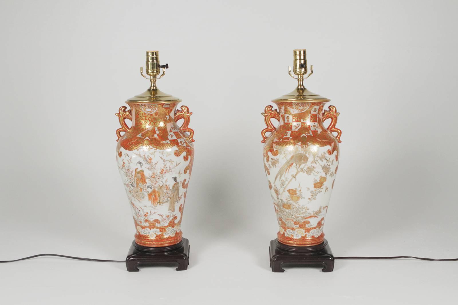 A pair of Meiji period Kutani vases Japan, circa 1890 with stylized handles, with finely painted figures and phoenix birds-now as lamps. The lamps are 8 inches wide, 21 height to top of the to socket, 30 inches to the top of the shade.