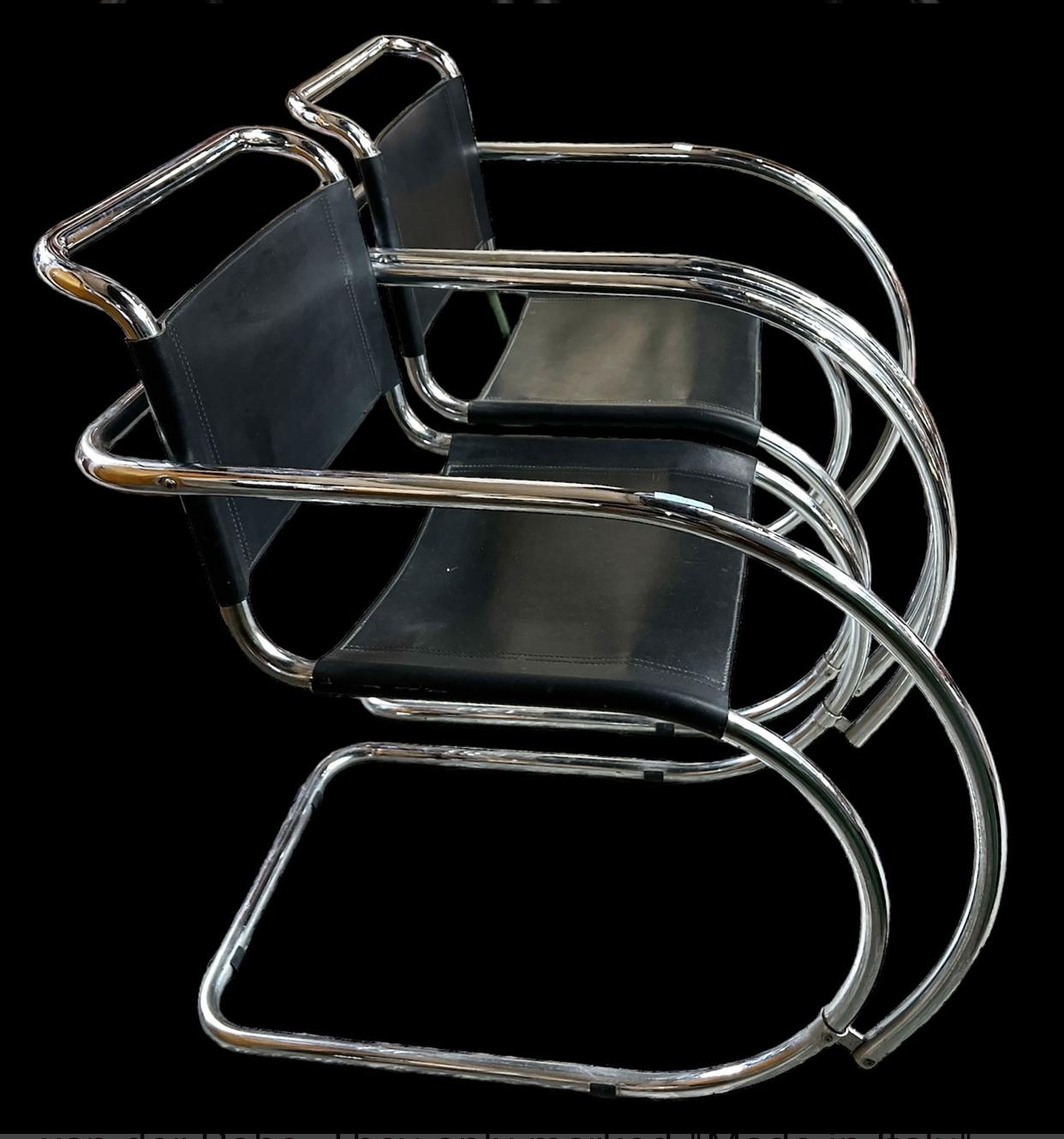 Pair of leather and chromed steel cantilevered arm chairs designed by Ludwig Mies Van Der Rohe.  There is no manufacturer listed but they do have “made in Italy” tags on them. Similar in materials to the Italian manufacturer Gavina. The main photo