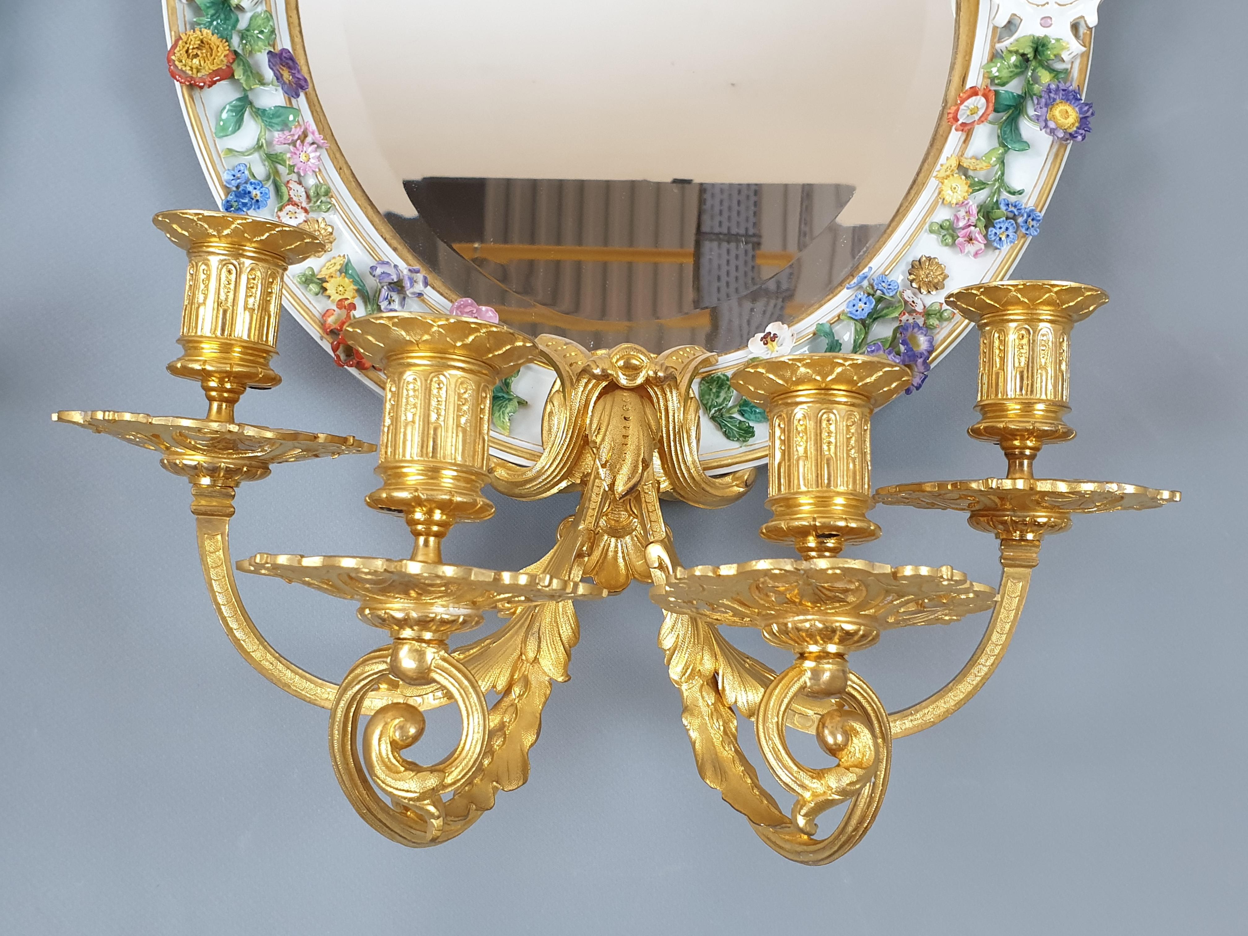 Extremely rare pair of sconces, consisting of porcelain mirrors decorated with figures of Putts and floral motifs, combined with gilt bronze arms, Meissen, circa 1870. Perfect condition, highest quality porcelain and bronze castings. Collectible