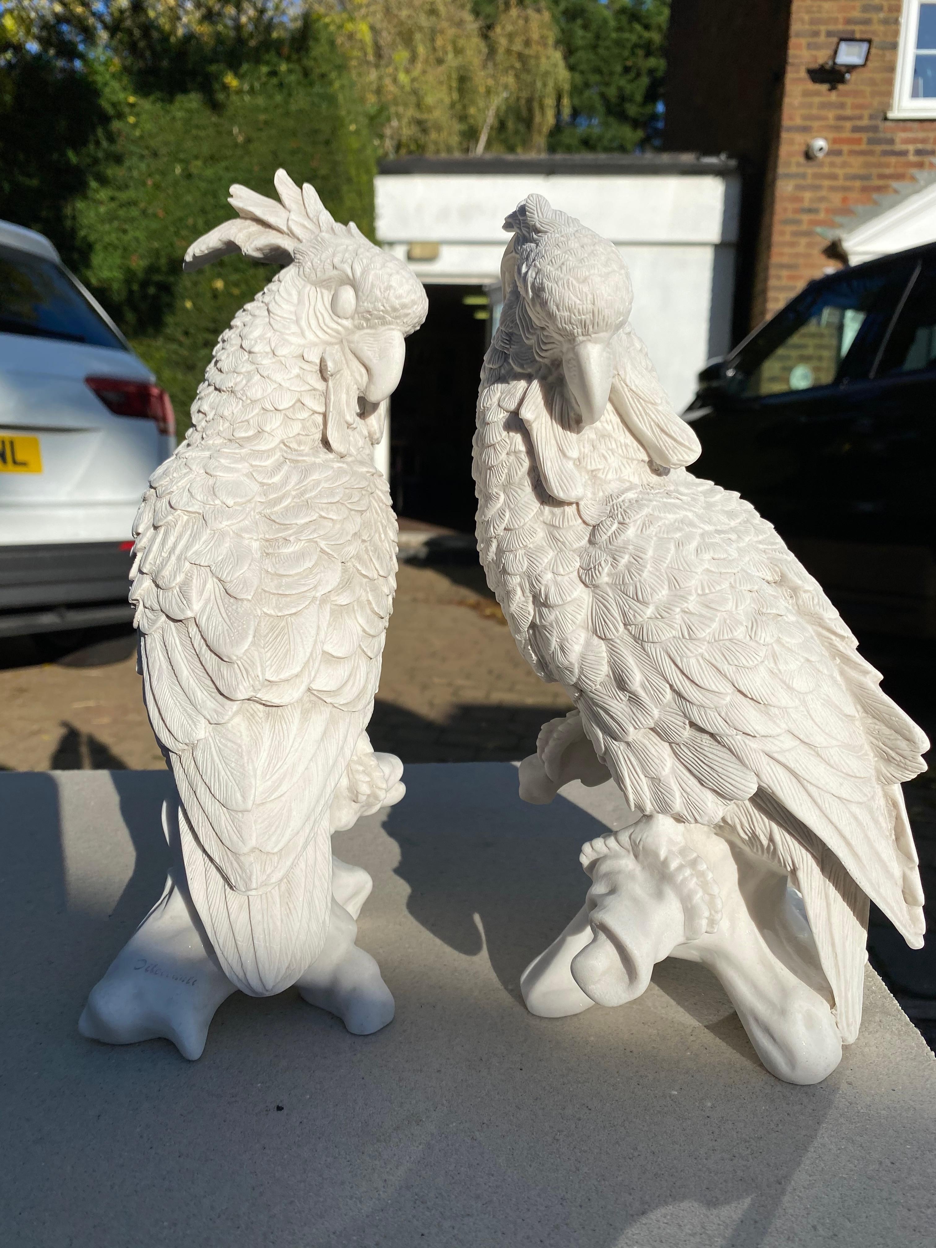 This elegant pair of Meissen porcelain parrots, crafted in the 20th century, exemplifies the fine artistry and intricate craftsmanship for which Meissen is renowned. Each parrot is meticulously hand-painted with vibrant colors and detailed feather
