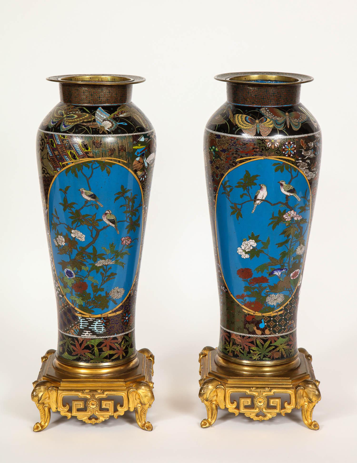 A magnificent large pair of Meji period Japanese cloisonné thousand butterfly vases with French Barbedienne ormolu mounted bases in the chinoiserie taste. This gorgeous pair of Japanese cloisonné vases are of extraordinary craftsmanship. The