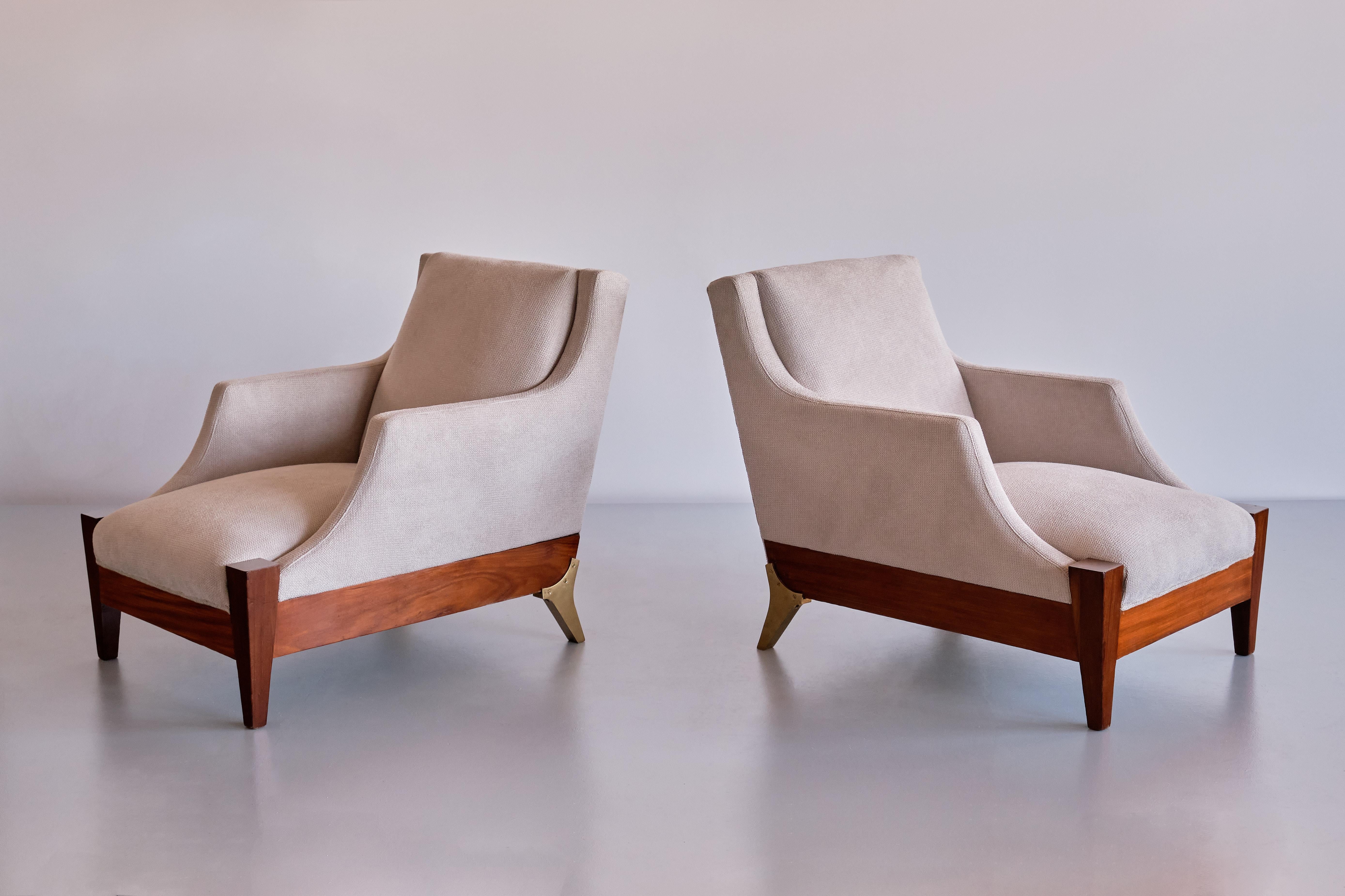 This exceptionally rare pair of armchairs was designed by Melchiorre Bega and produced in Italy in the late 1940s. The design is marked by the elegant, elongated frame and the curved lines of the armrest. The lower frame is in solid walnut wood with