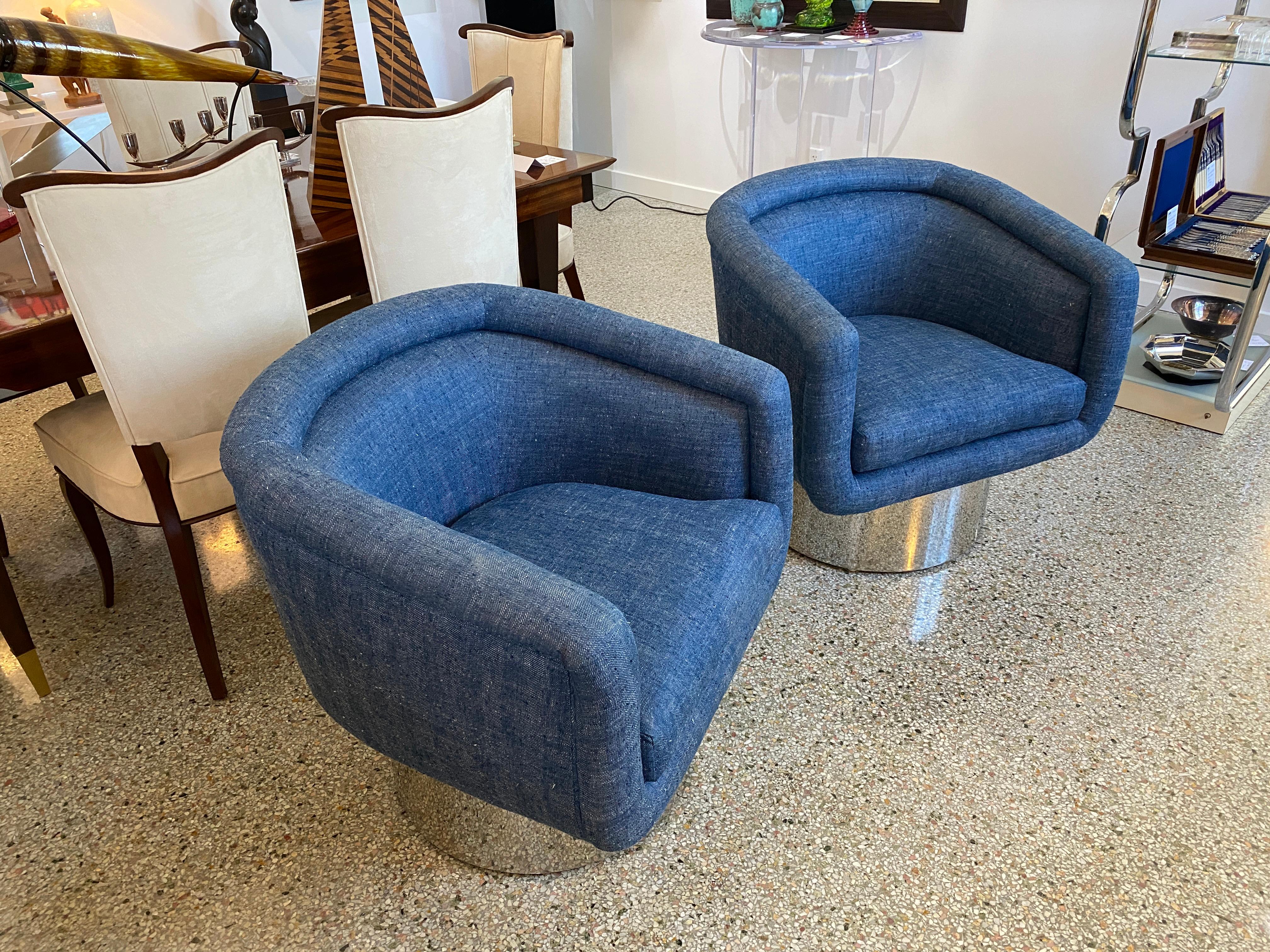This stylish pair of memory-swivel chairs date to the 1970s-1980s and were designed by Leon Rosen for the Pace Furniture Company. The fabric is a woven texture in blue with soft white warp yarn.