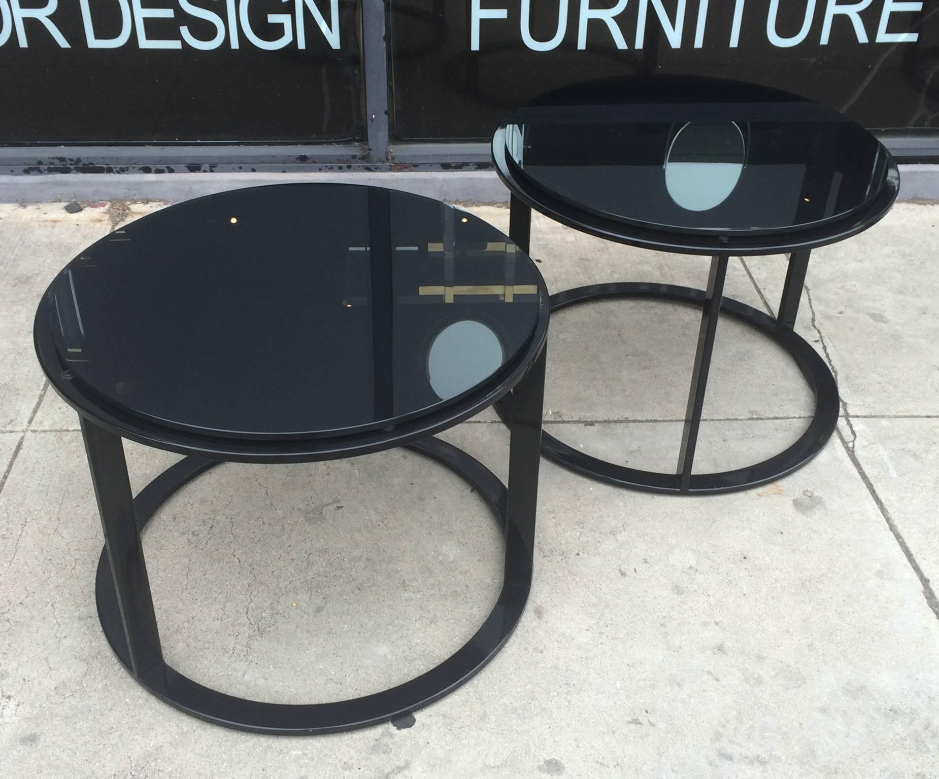 Beautiful set of side tables in black tubular steel and reverse painted black glass tops designed by Antonio Citterio and manufactured by B&B Italia.

These tables can be used together or separate and they are perfect for small places or