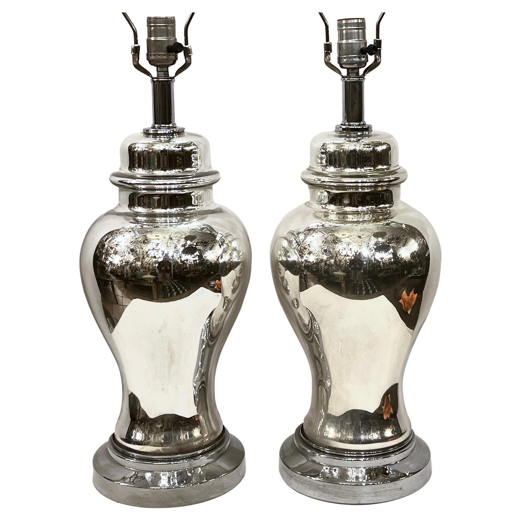 Pair of French circa 1920s mercury glass table lamps with metal bases.

Measurements:
Height of body: 17