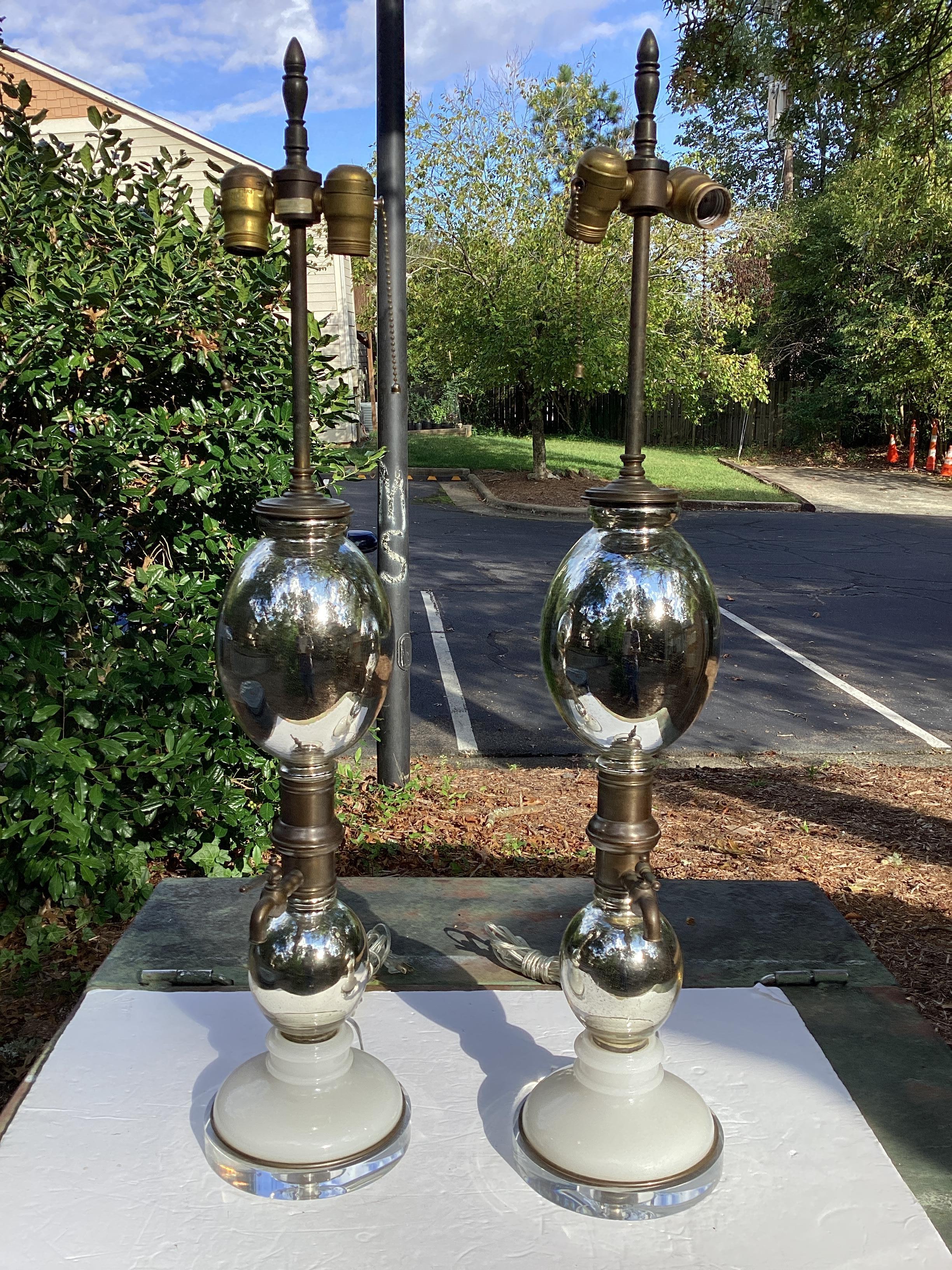 Pair of Mercury Glass Seltzer Bottle Lamps by Warren Kessler. Mercury glass with brass fittings and opaline glass mounted on a lucite base. Lamps are wired and in working condition with double sockets.