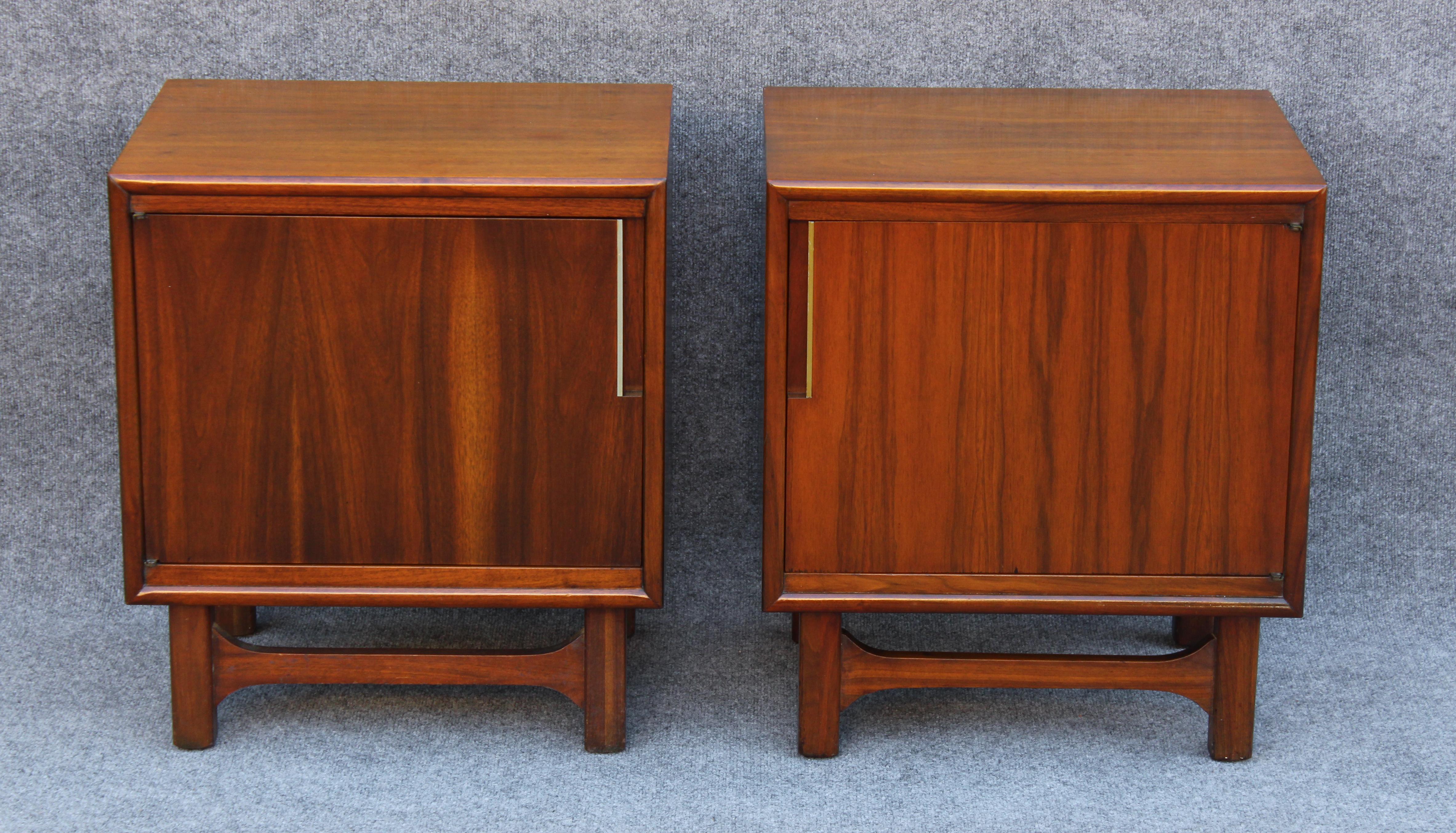 Designed by Merton Gershun in the late 1960s for Cavalier, these nightstands or end tables feature a super refined design and great construction quality. Well built, they are constructed of walnut with a warm stain and have brass accents at the