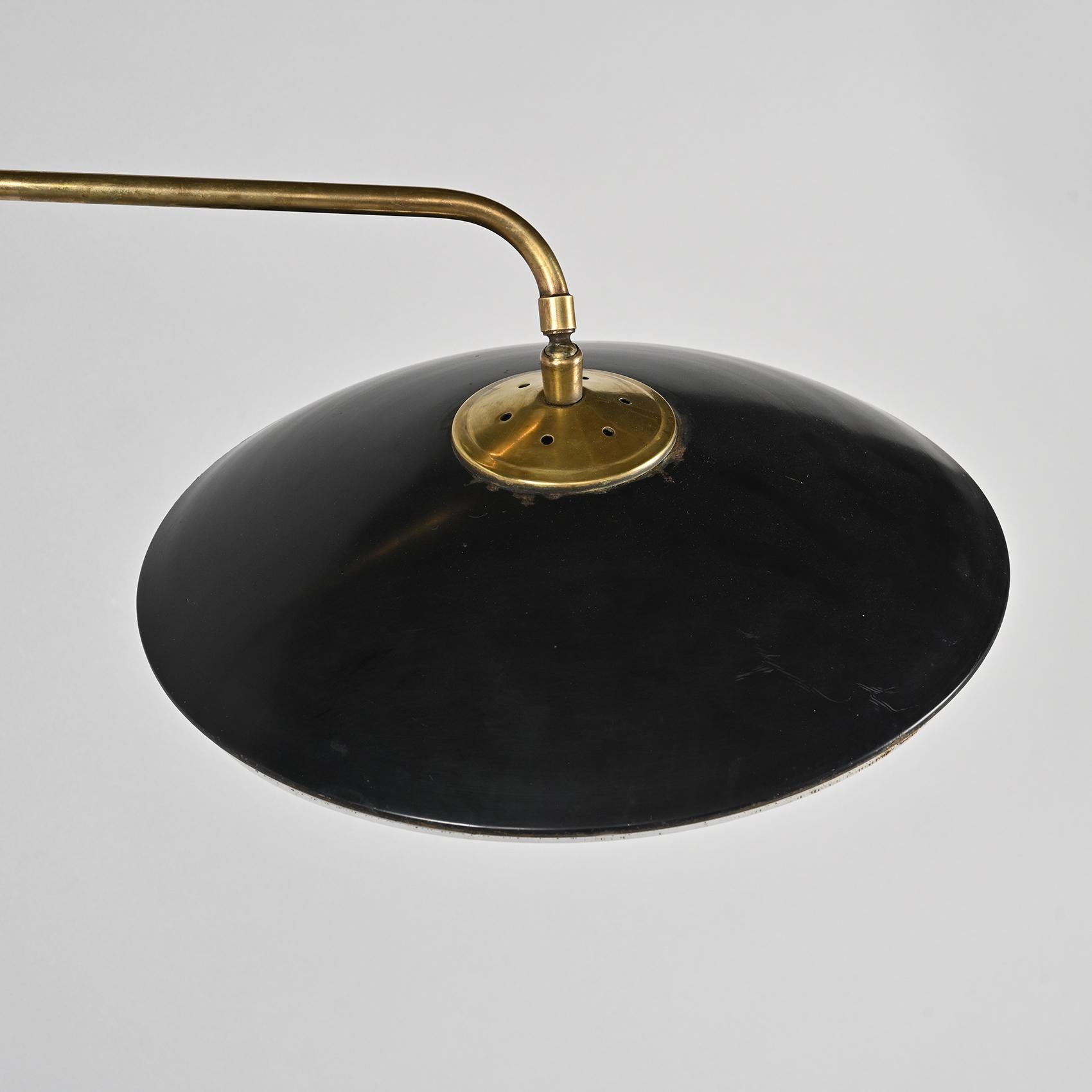 We love the 1950s modernism exuded by this set of grand wall-mounted articulated sconces, released by Maison Arlus France during the 1950s.

Emerging from the wall mount is a bent arm made of gilded brass, which upholds the saucer-shaped diffuser
