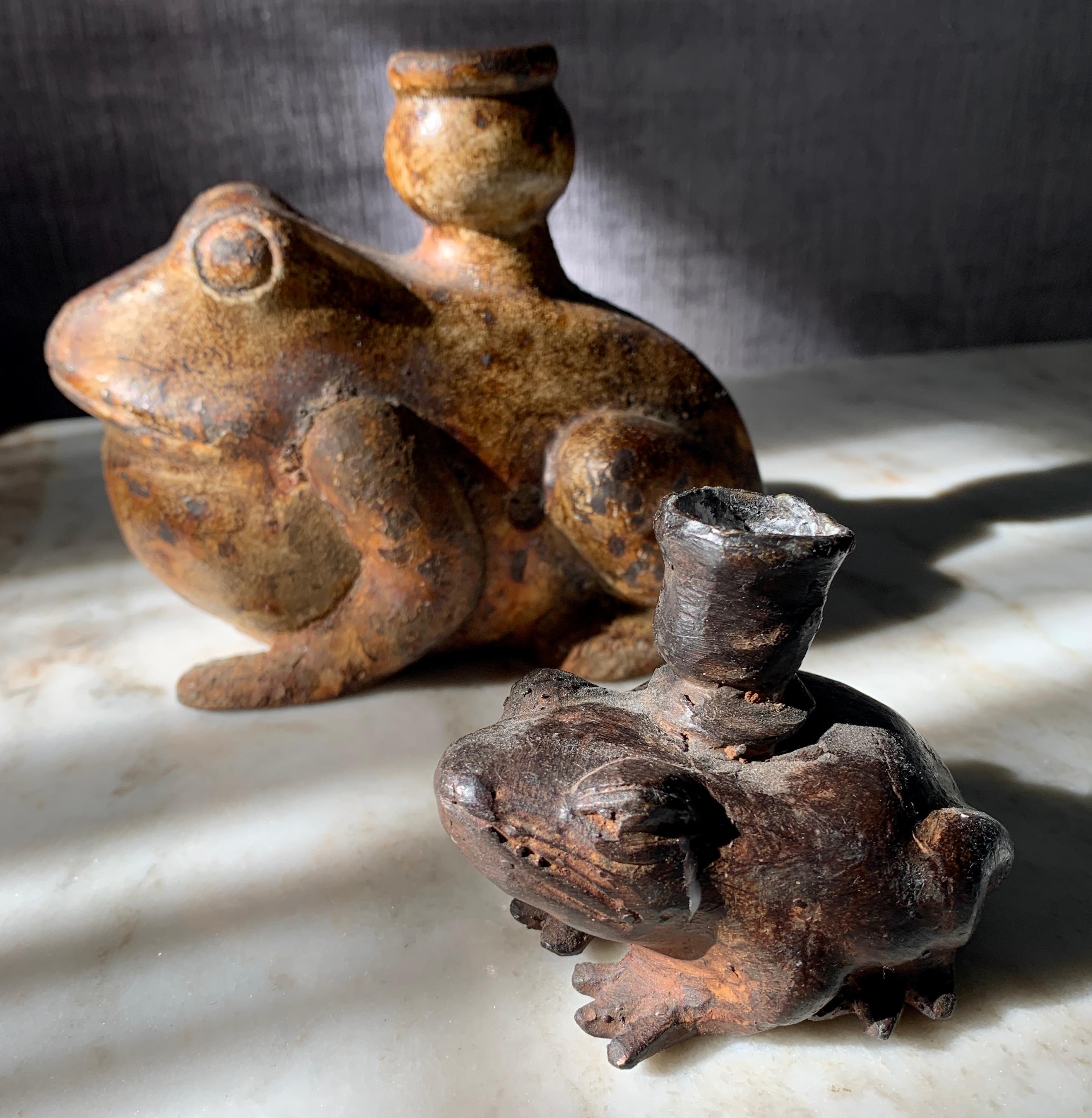 A pair of frogs, both wonderfully patinated. The smaller is a bronze specimen and stunning in it's design and age. The larger is cast or wrought iron and equally stunning in presence, the pair make a great duo on any table of dinner table, as