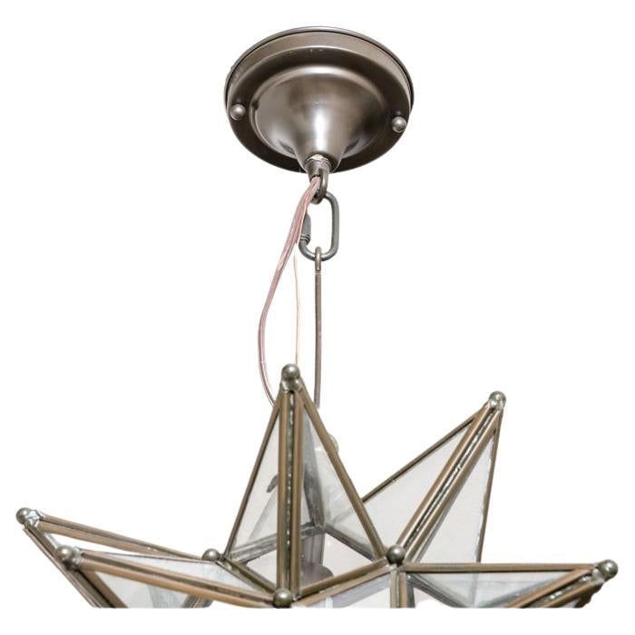 Decorative Pair of bronze finished metal and glass Moravian Star lighting fixtures with front lift up access. Beautifully configured with a hook hanger and a ceiling plate. Takes 1 bulb. 

Dimensions: 13” by 13”. 

Condition: Please see detail