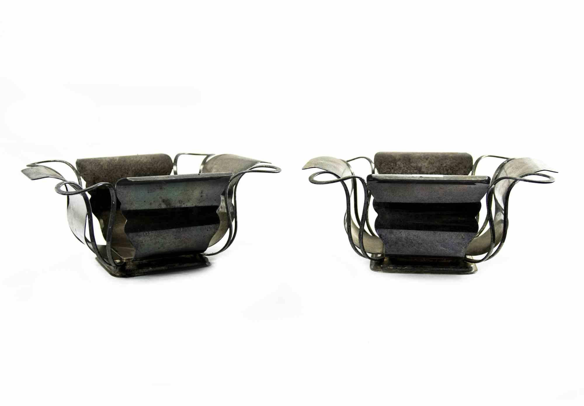 Pair of metal centrepiece is an original decorative object realized in the Mid-20th Century.

Made in Italy.

The centerpieces are in good conditions. Some dirty spots on the surface are present. 

Total dimensions: 11 x 26 x 26 cm.