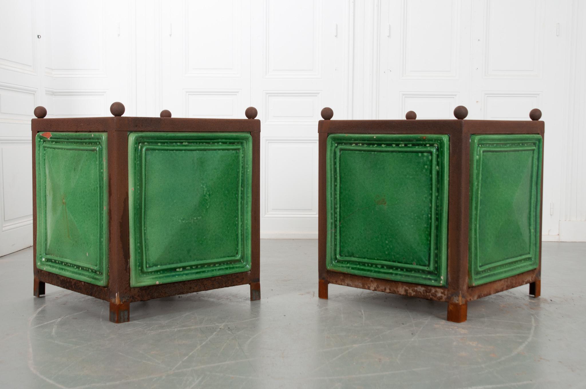 An eye-catching vintage pair of planters made of sturdy metal and green glazed terracotta.The design is a direct influence from the citrus gardens in Versailles. To protect the orange trees from harsh winters, a transportable planter was invented to