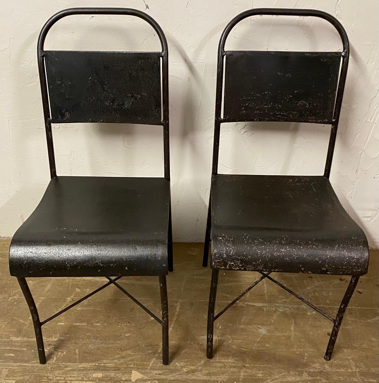 Pair of metal back and seat chairs with tubular frames. These Industrial chairs have taken on a truly special patina. The chairs would work well for both indoor and outdoor dining, and would add great character to an office as desk chairs.
Tolix