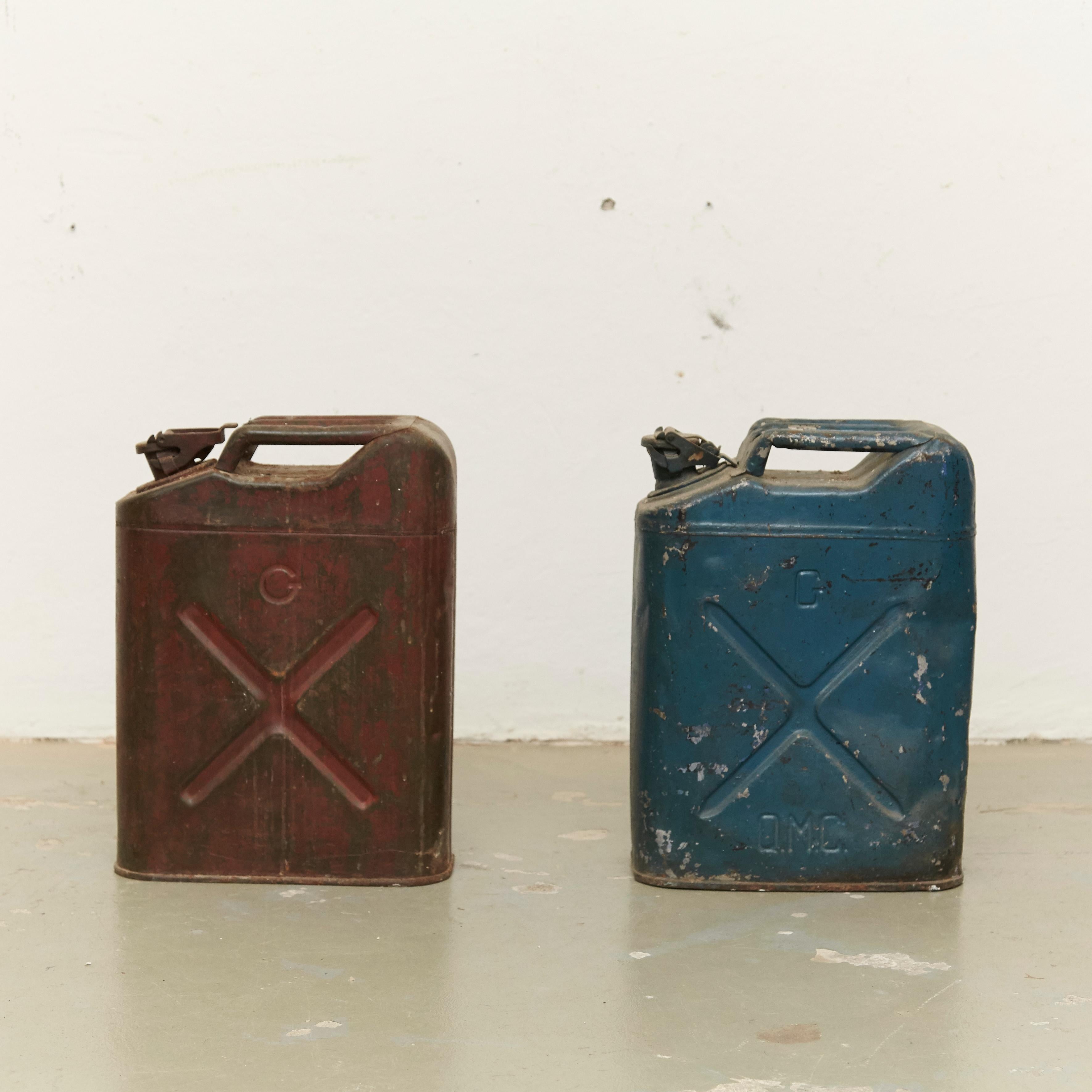 Pair of metal military red and blue gasoline tanks, circa 1950.