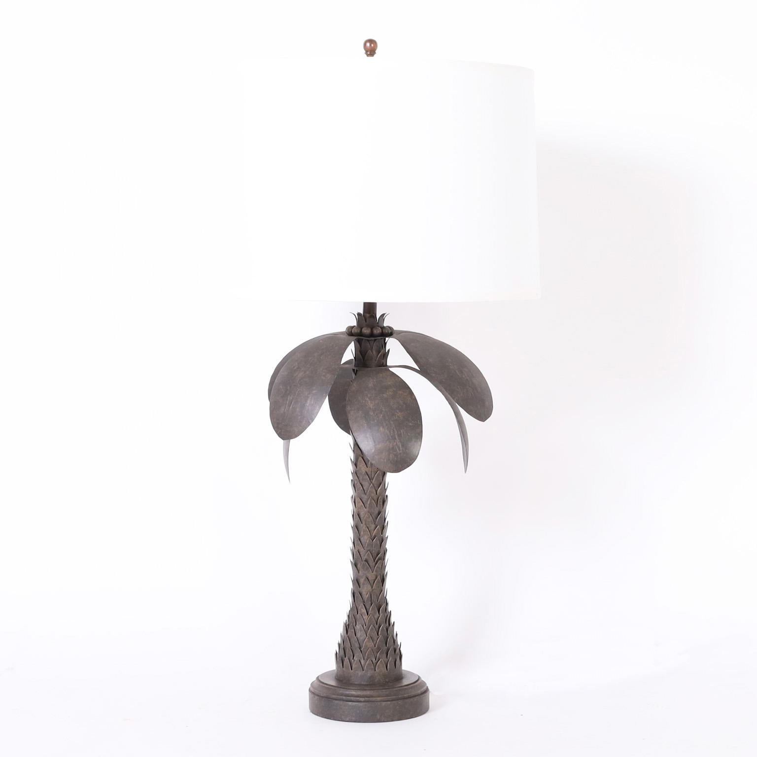 Standout pair of vintage palm tree table lamps crafted in metal with a chic raw metal finish having an unusual set of influences including stylization, industrial, brutalist, and tropical.