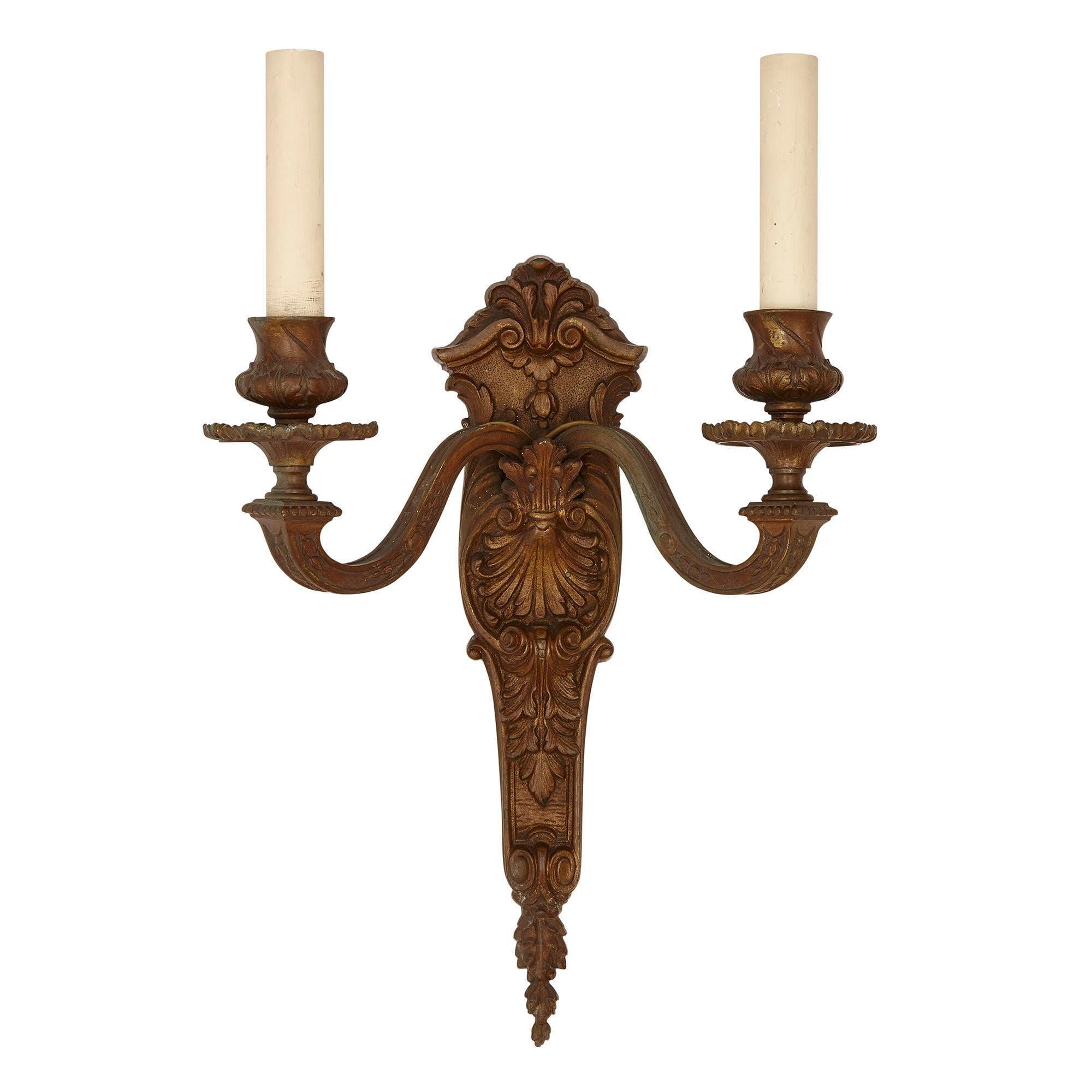 Pair of metal sconces designed in the neoclassical style
French, early 20th Century
Measures: Height 37cm, width 29cm, depth 15cm

This fine pair of sconces is crafted in the neoclassical style from metal. Each sconce features a backplate