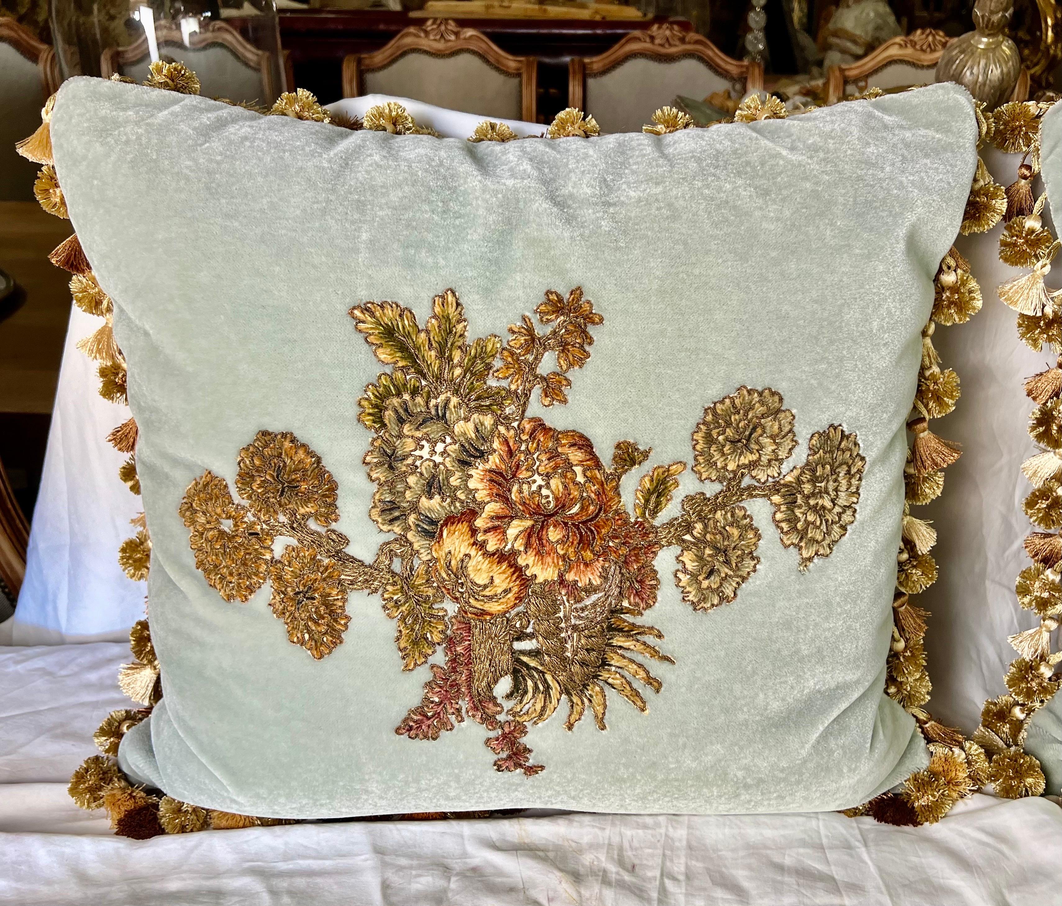 Custom pillows by Melissa Levinson, showcase 19th-century French metallic and chenille embroidered textiles on contemporary soft blue mohair backs.  The floral motifs, including hydrangeas and roses, along with the multi-colored fringe, add a touch