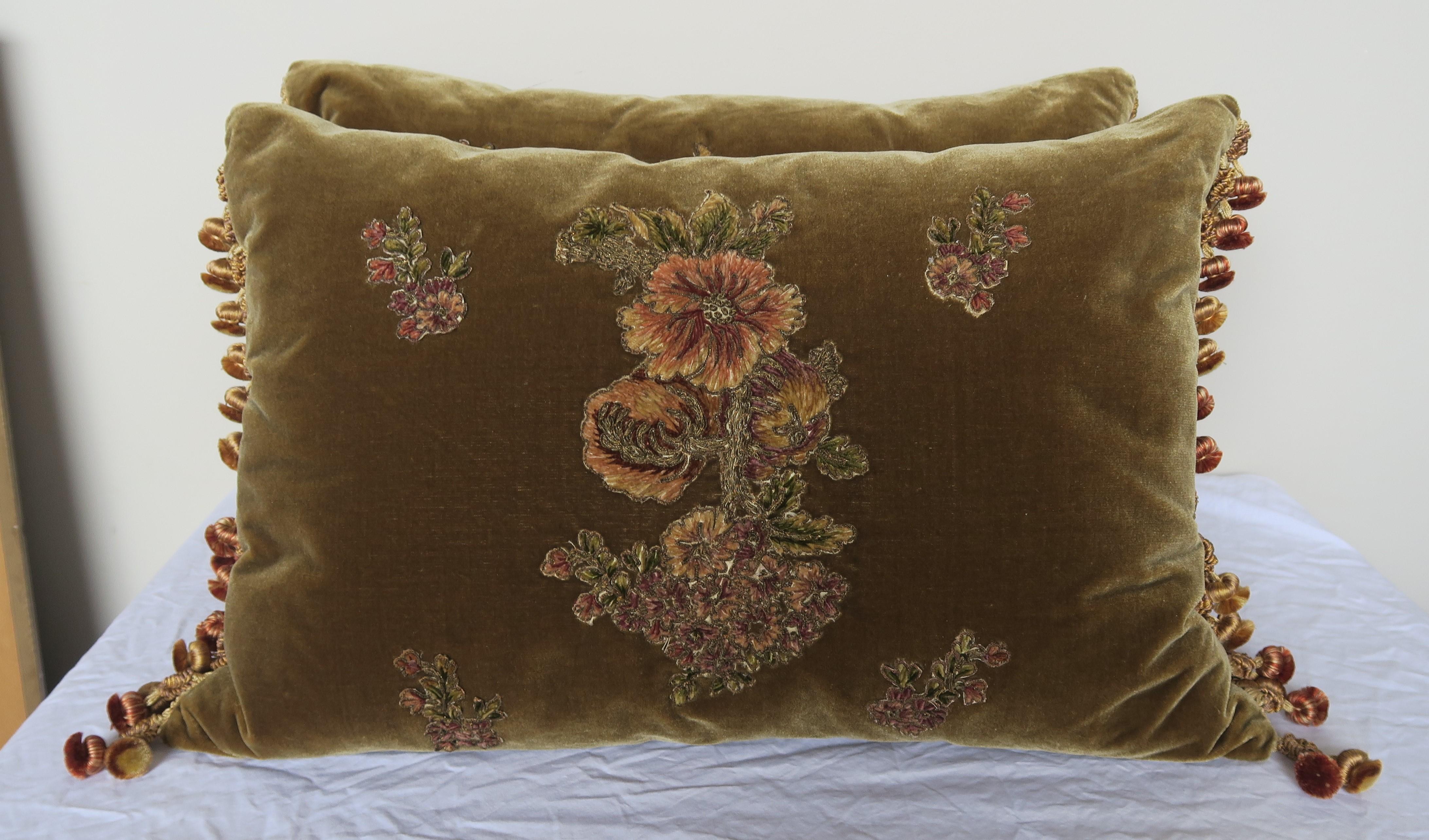 Pair of custom pillows made with 19th century French metallic and chenille appliquéd silk velvet fronts and silk backs. Tassel trim at sides of pillows. Down inserts, sewn closed.