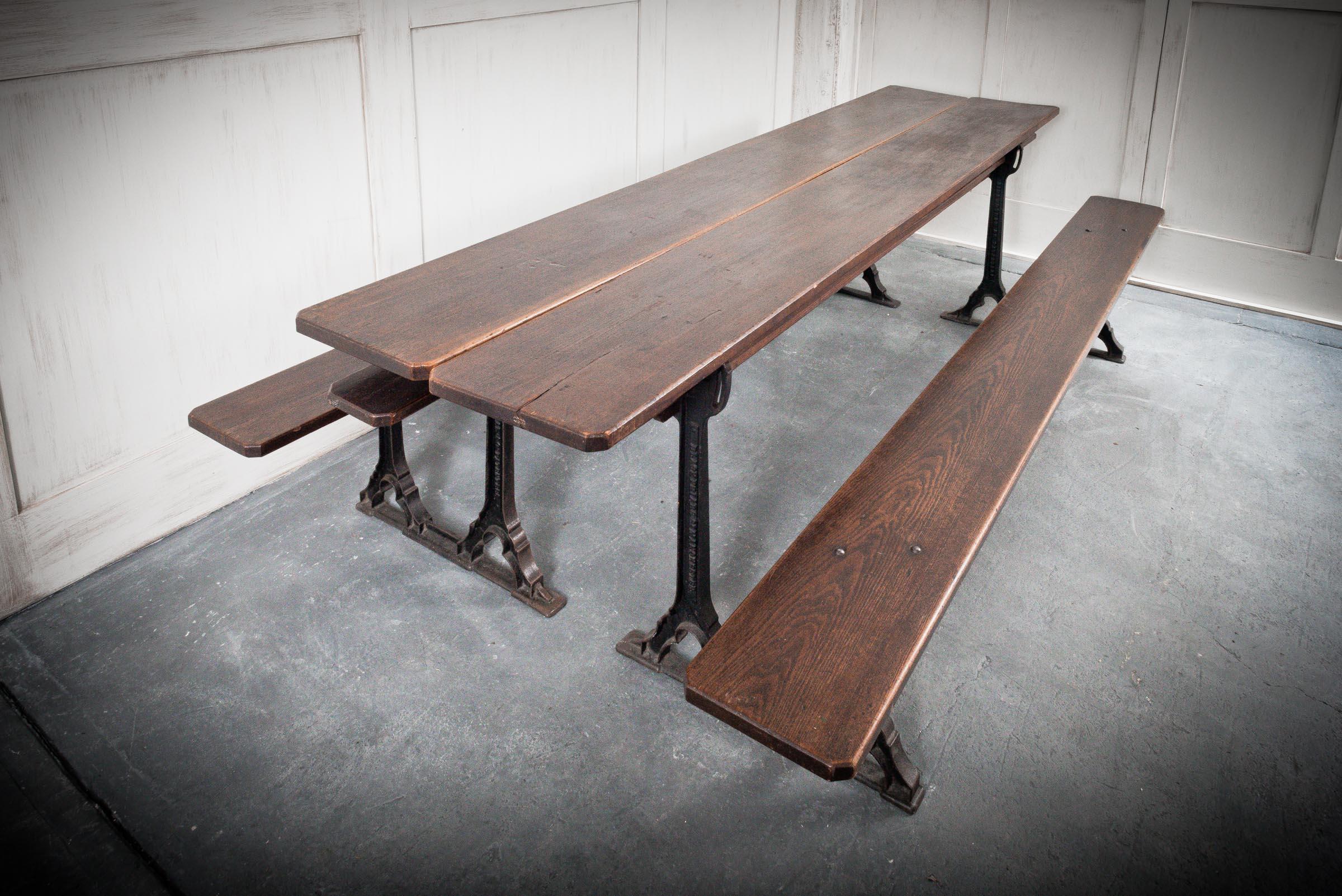 A charming metamorphic pair of benches that go together to form a single table typical of the Victorian era. English, Circa 1860, these benches were originally used at pews or school tables within churches. The dark pitch pine bench sits on a sturdy