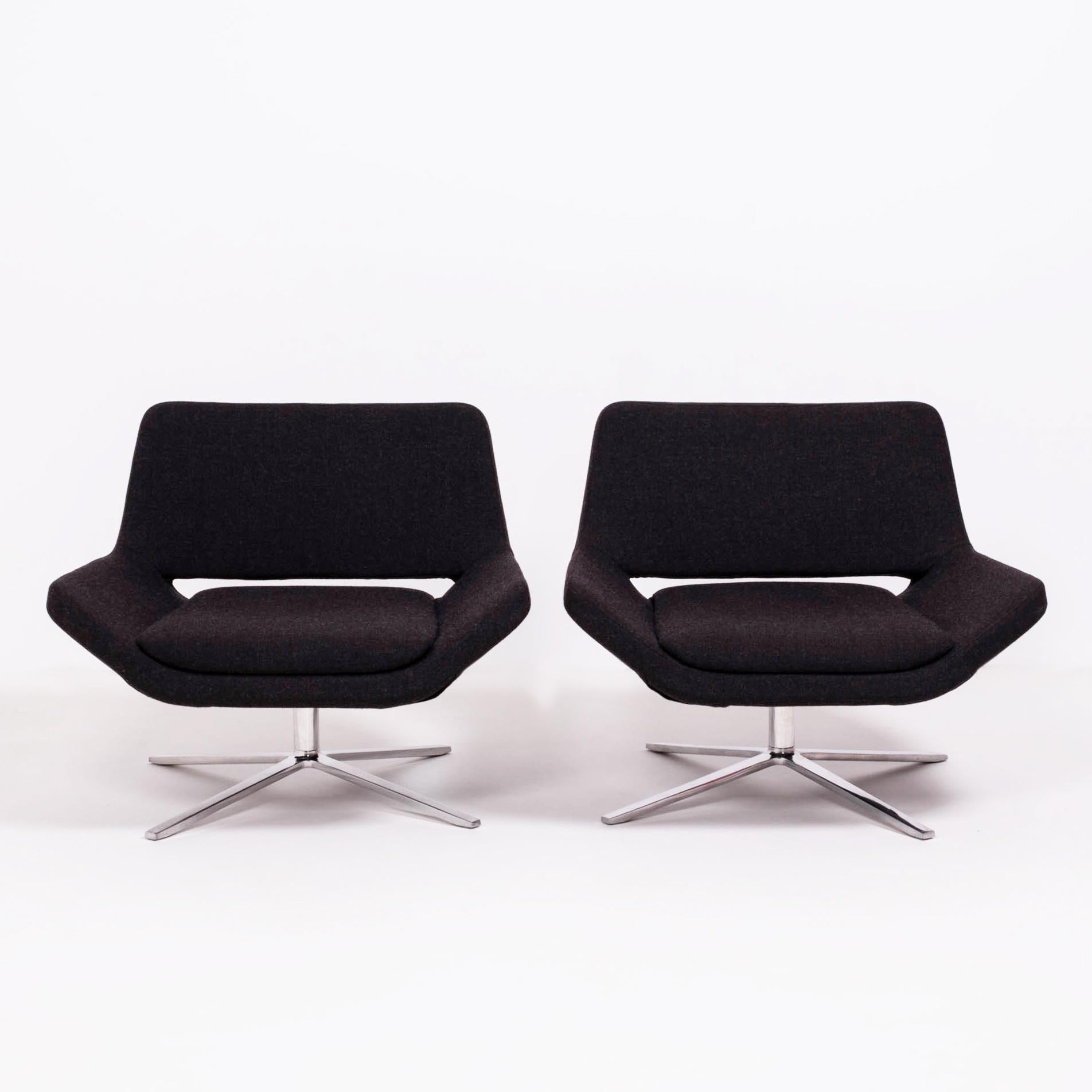 Originally designed in 2002 by Jeffrey Bernett for B&B Italia, this pair of Metropolitan armchairs have a sleek, modernist aesthetic. 

Fully upholstered in dark grey fabric, the armchairs feature seats that flow uninterruptedly into angular arm