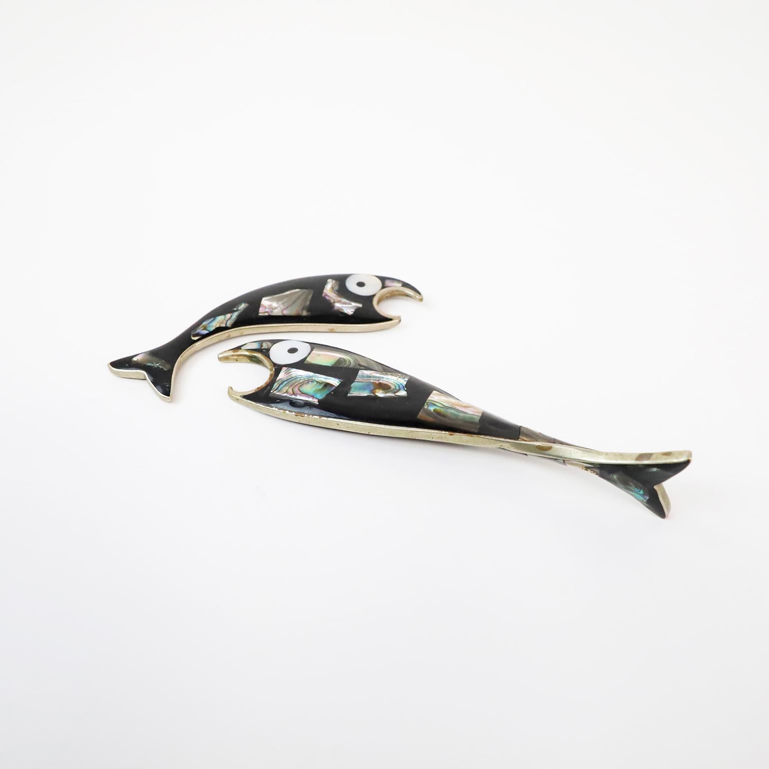 Beautiful vintage Mexican abalone shell and iron pair of bottle openers in the form of fish.