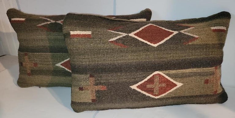 Pair of Mexican Indian weaving pillows. Olive, Off White, Greens, Rust colors.
Green Velvet Backing. Zippered casing and Feather/Down insert.