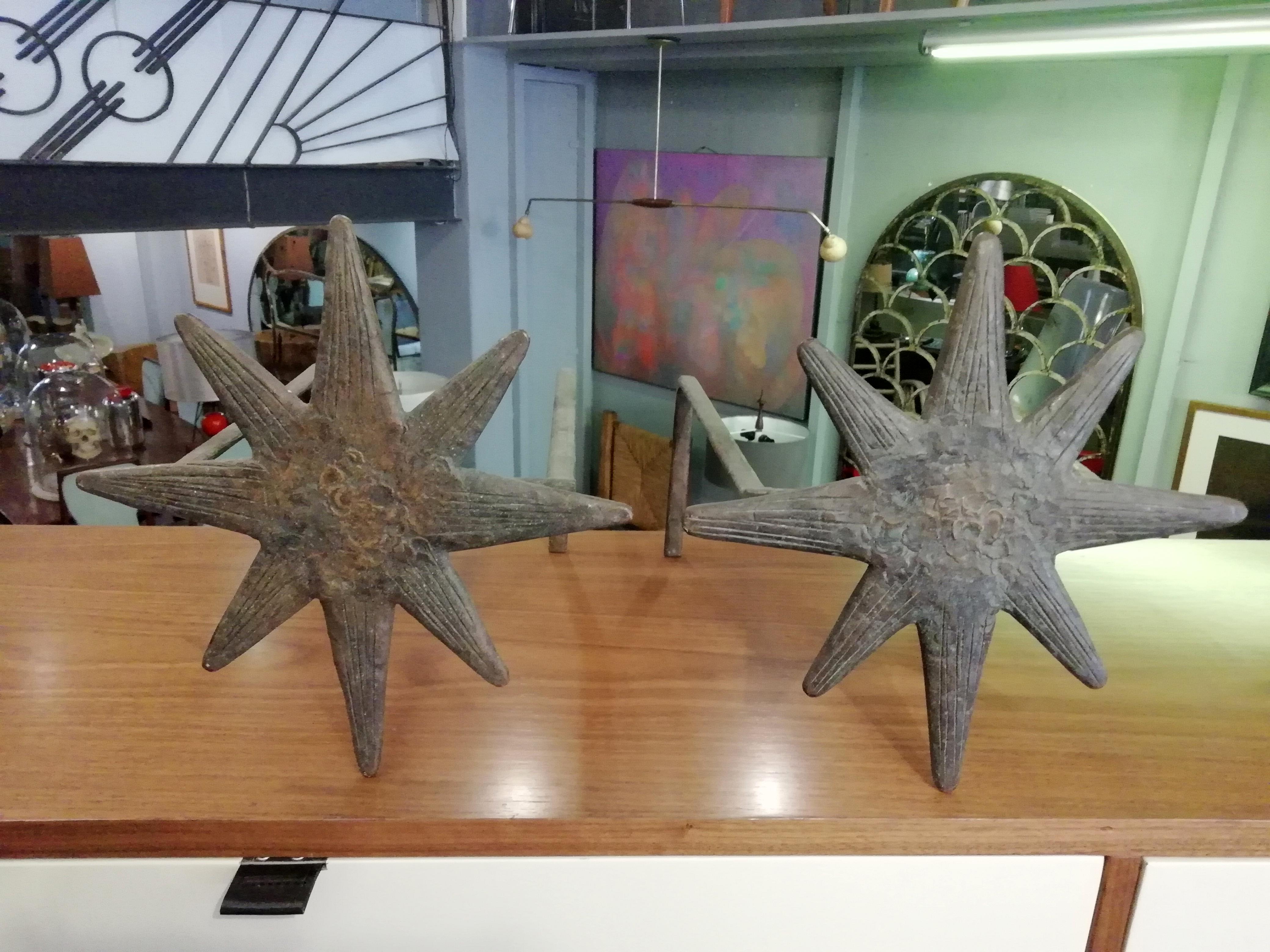 Exquisite pair of Mexican Mid-Century Modern patinated bronze andirons in the style of Diego Giacometti with 8-pointed star design.