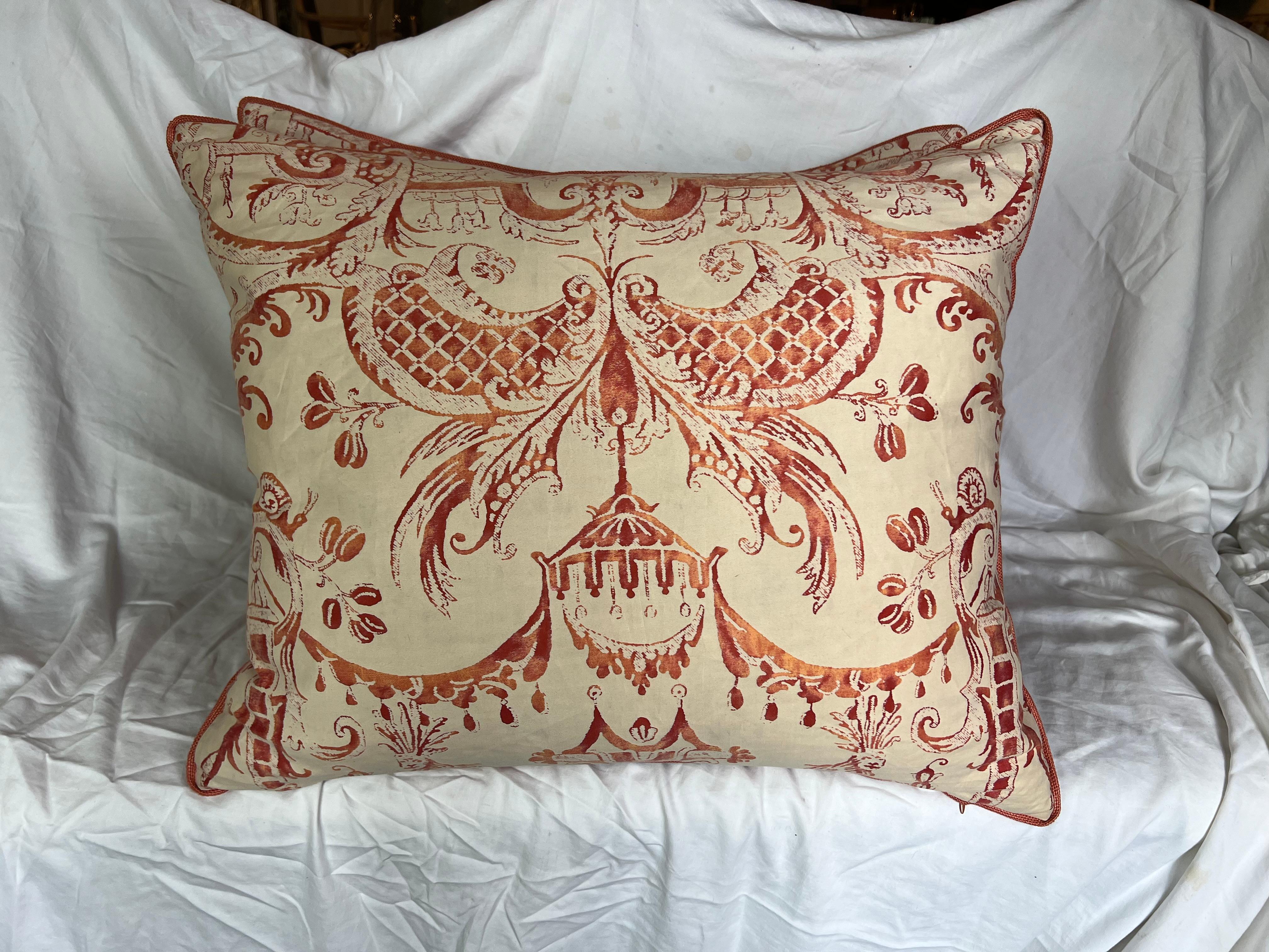 Pair of custom pillows with Fortuny's Mezzianno patterned bittersweet on ivory on the front and a solid rich rust linen on the backs.  The pattern interpreted from designs of Jean Berain, depicting addorsed and confronting monkeys and lions set