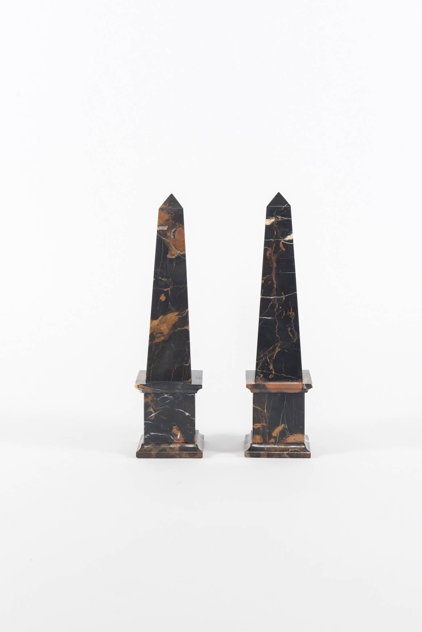 A vintage pair of Michael Angelo marble obelisks.