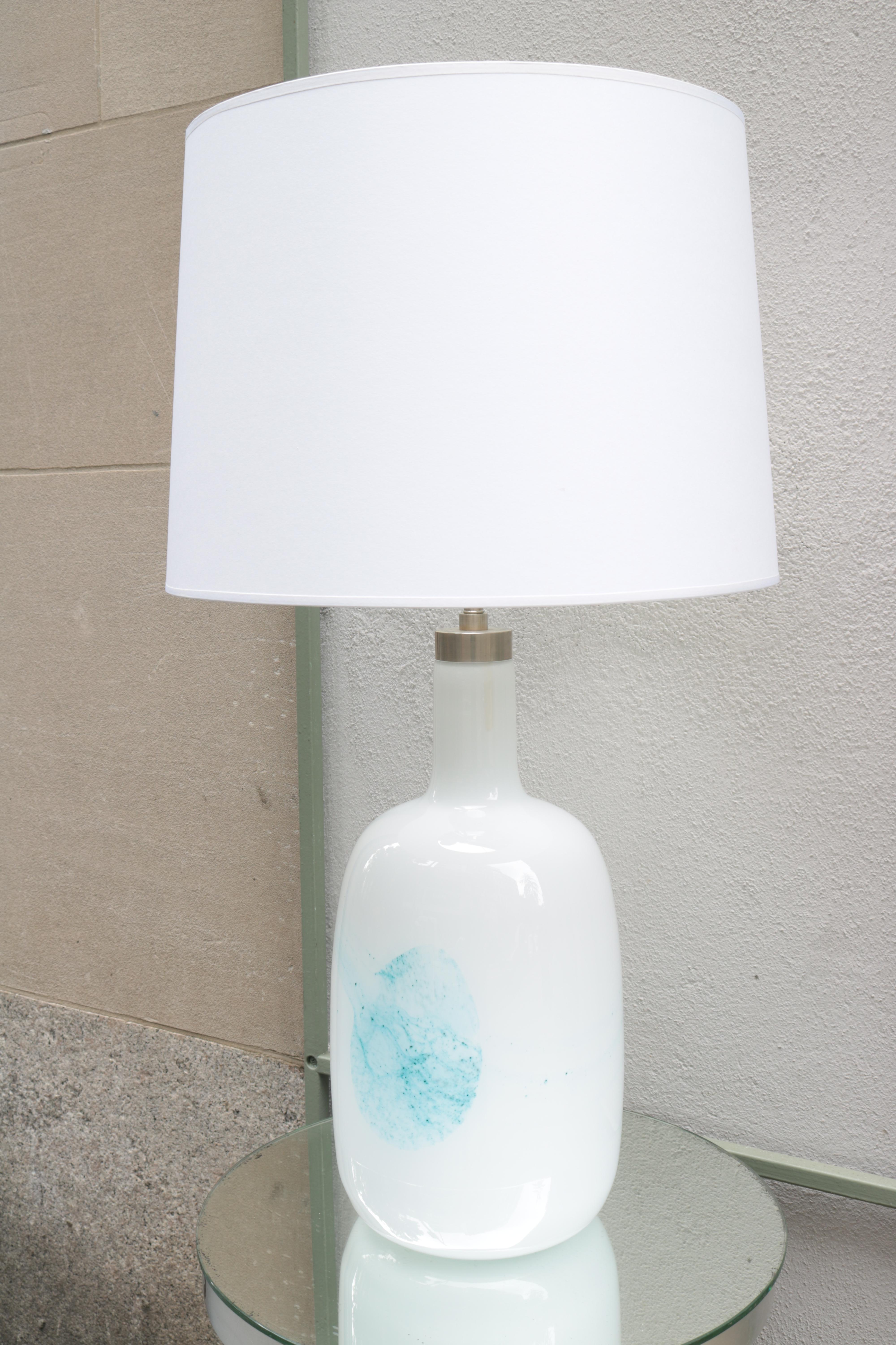 A pair of Michael Bang designed for Holmegaard Modernist table Lamps.
White cased glass with abstract light blue swirl details and nickel fittings.