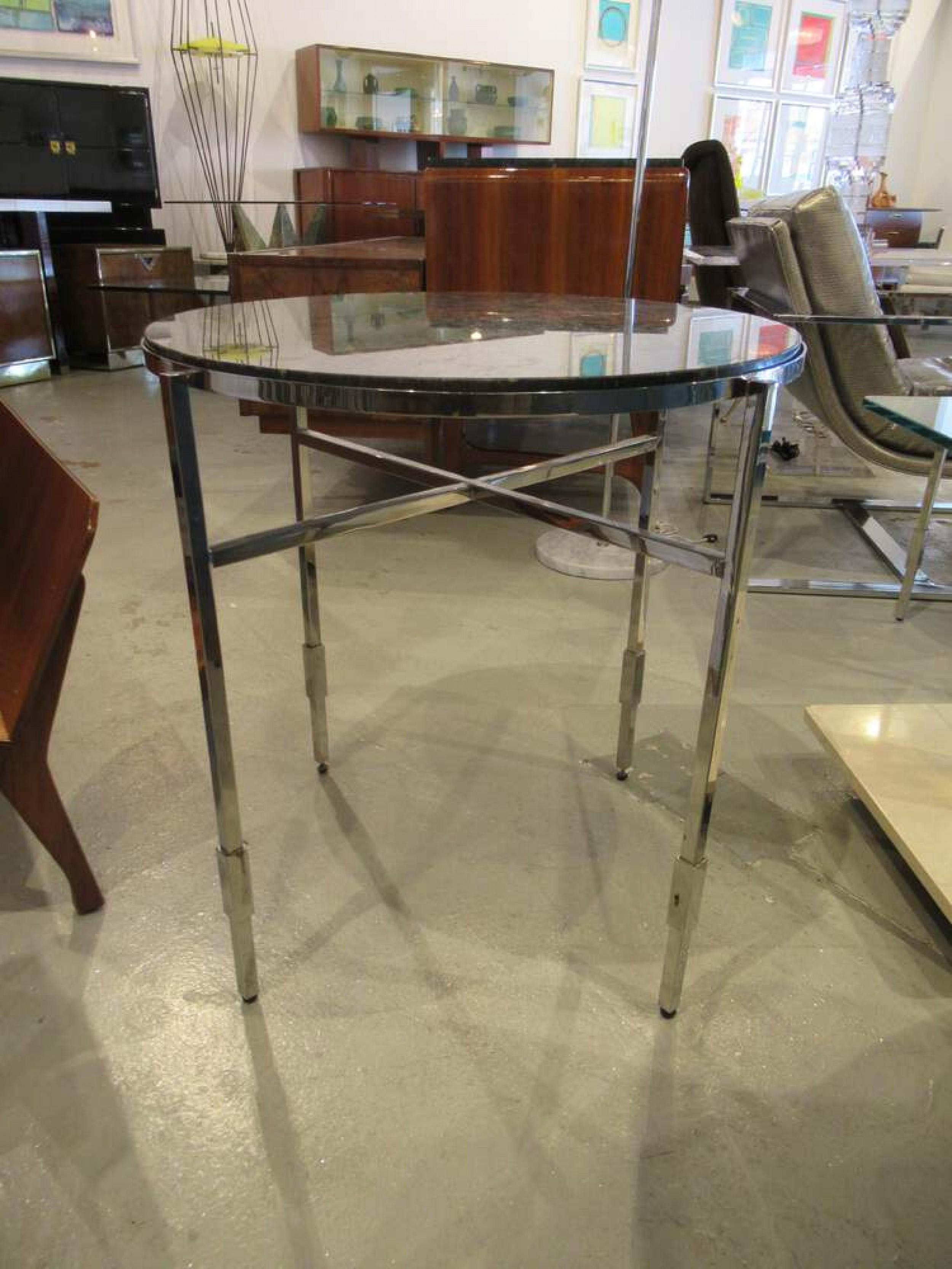 PAIR of American Modern end / side tables with polished chrome frames and circular dark granite tops. (MICHAEL GRAVES)(PRICED AS PAIR)
