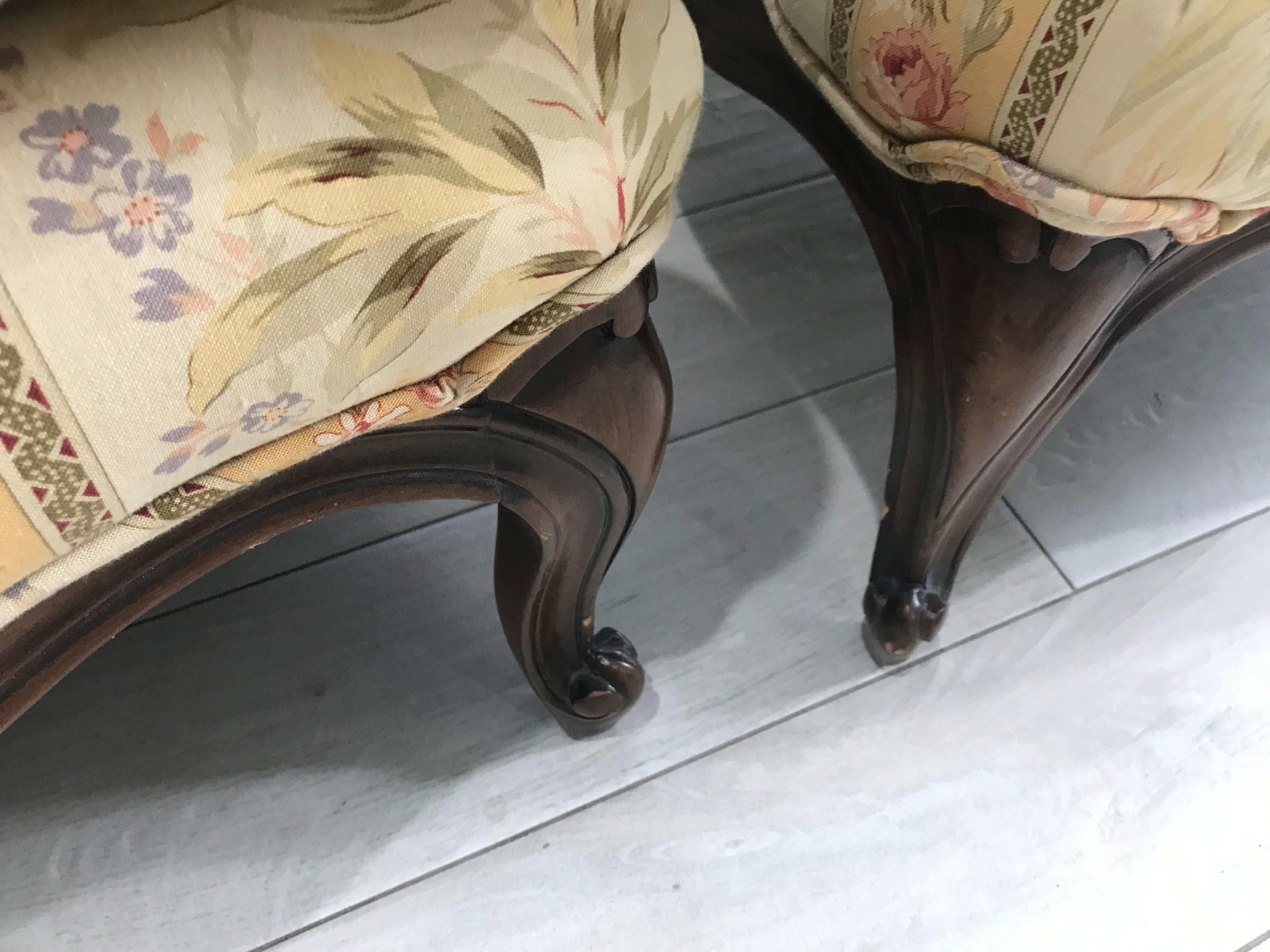 This lovely pair of Bergeres are finished in a walnut color. The back cushion is down filled and the quality is quite nice overall. They are oversized and comfortable. The fabric is in very good condition. 