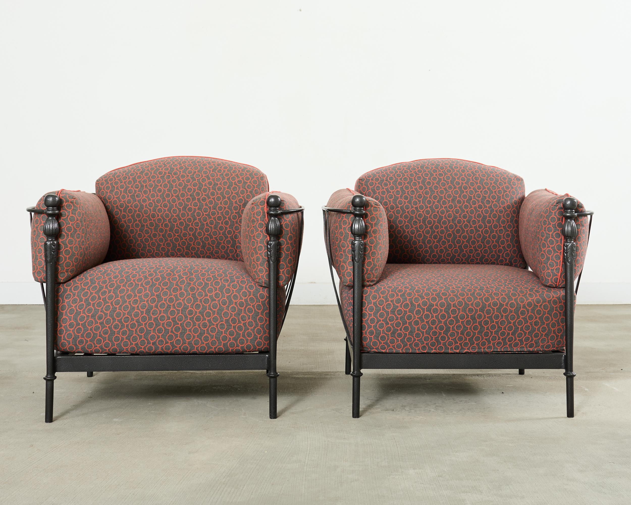 Iconic pair of patio and garden Montecito chairs designed by Michael Taylor. The pair features recently re-powder coated frames in a very dark gun metal finish. The generous frames are topped with oversized cushions in whimsical, geometric colorful